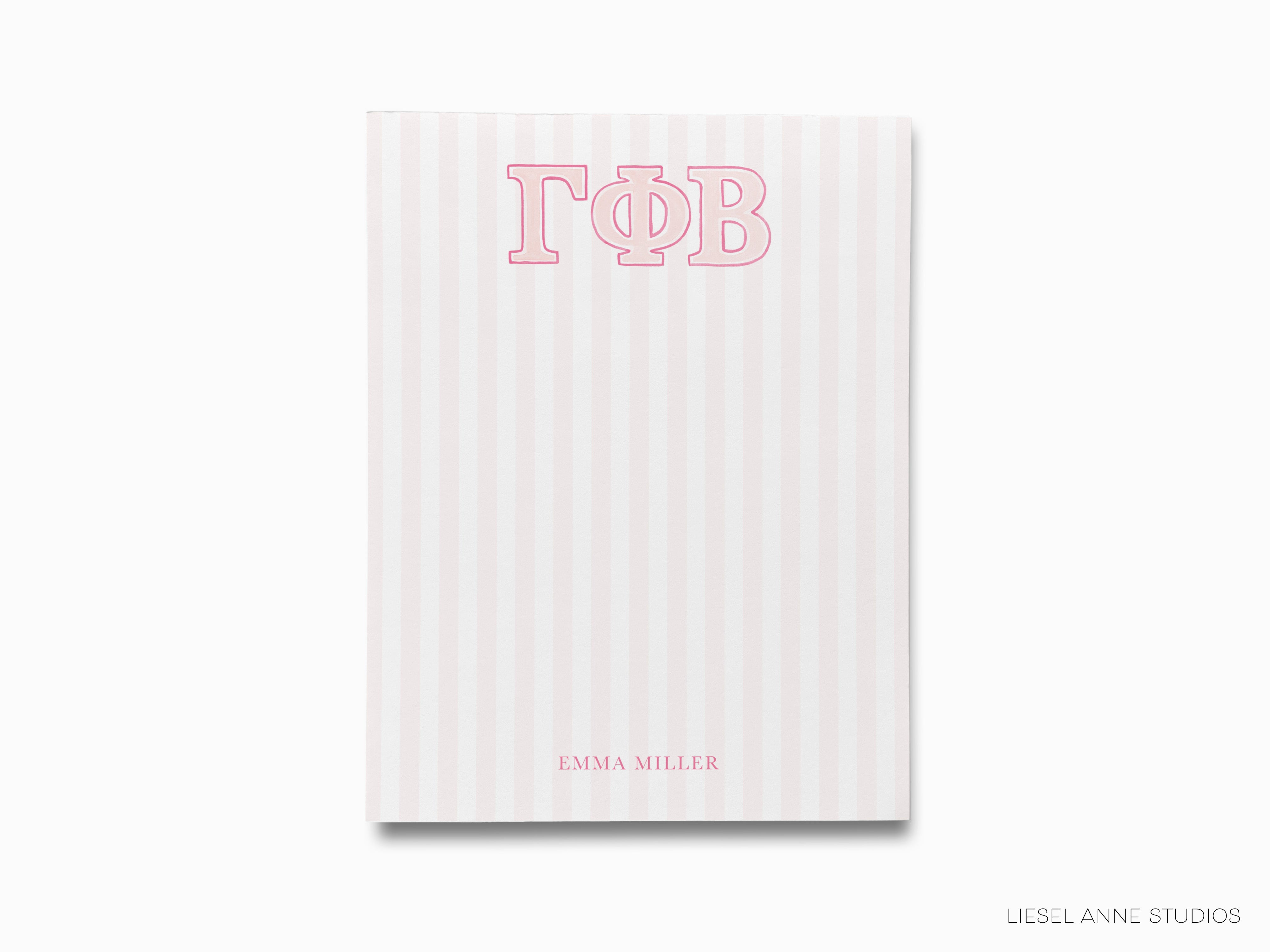a pink and white striped notebook with the word top on it