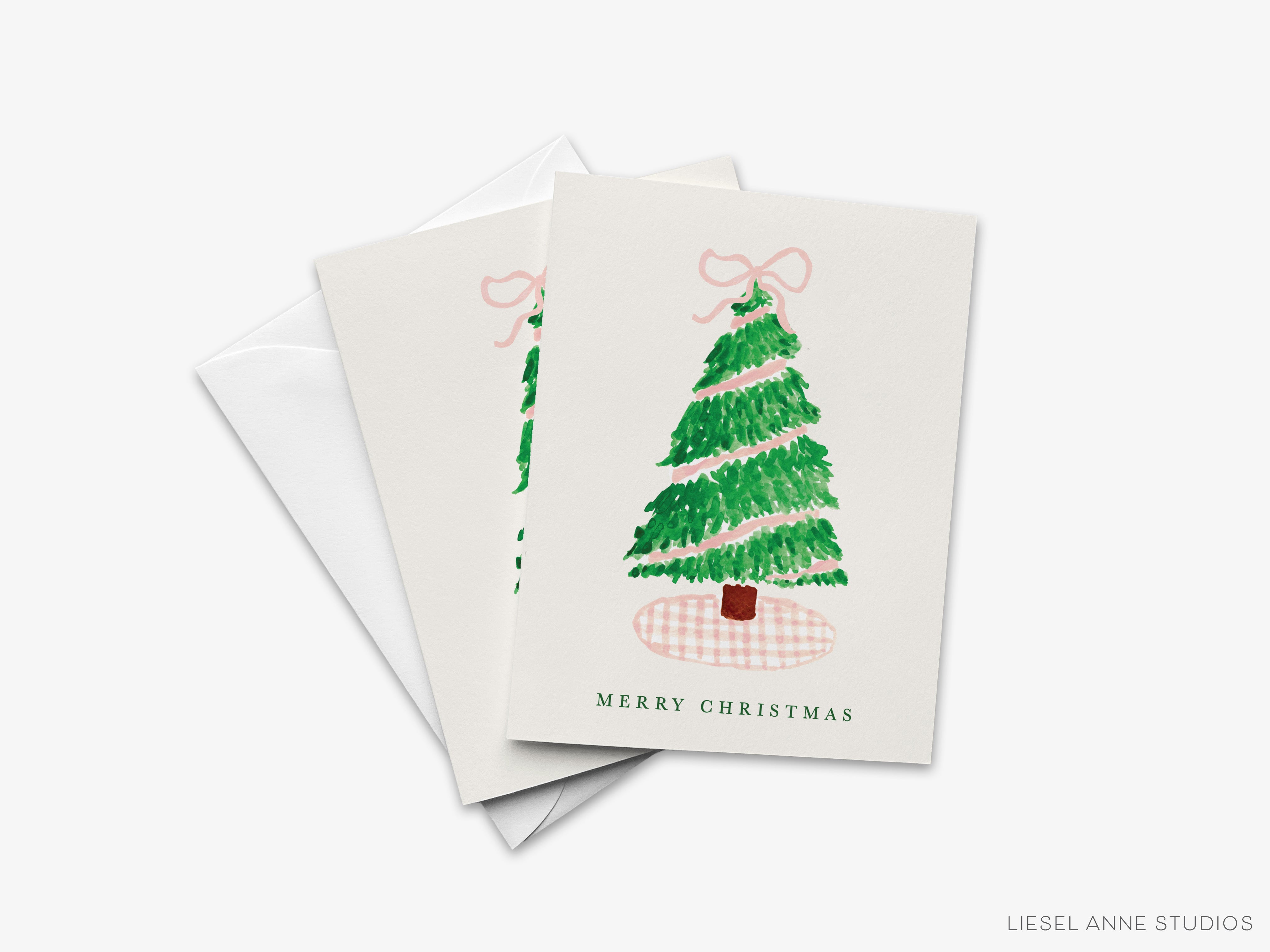 A white Christmas card with a green tree illustration and the text "MERRY CHRISTMAS" printed on it.