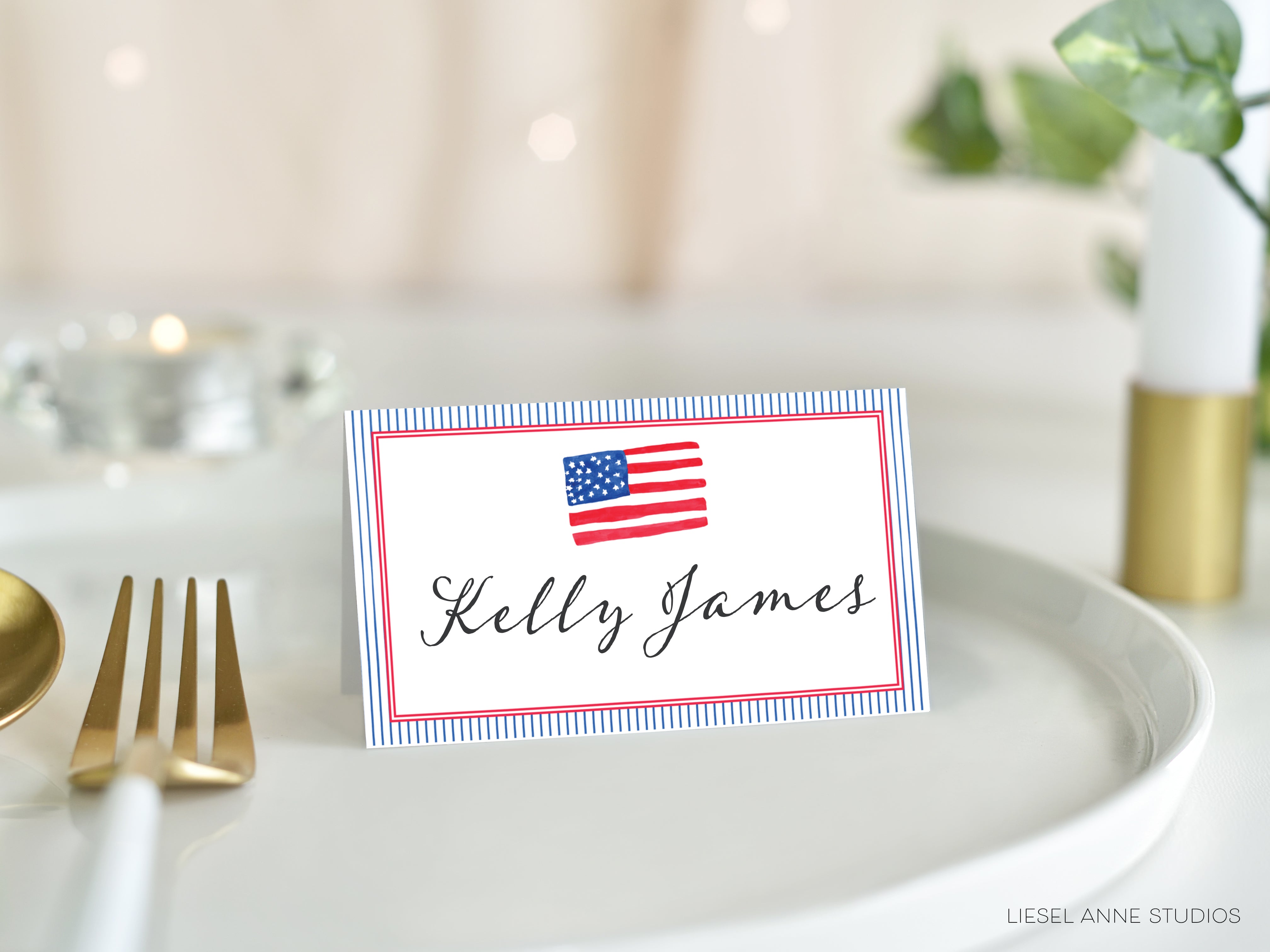 A place card with the name 'Keely James' on it, placed on a white tablecloth.