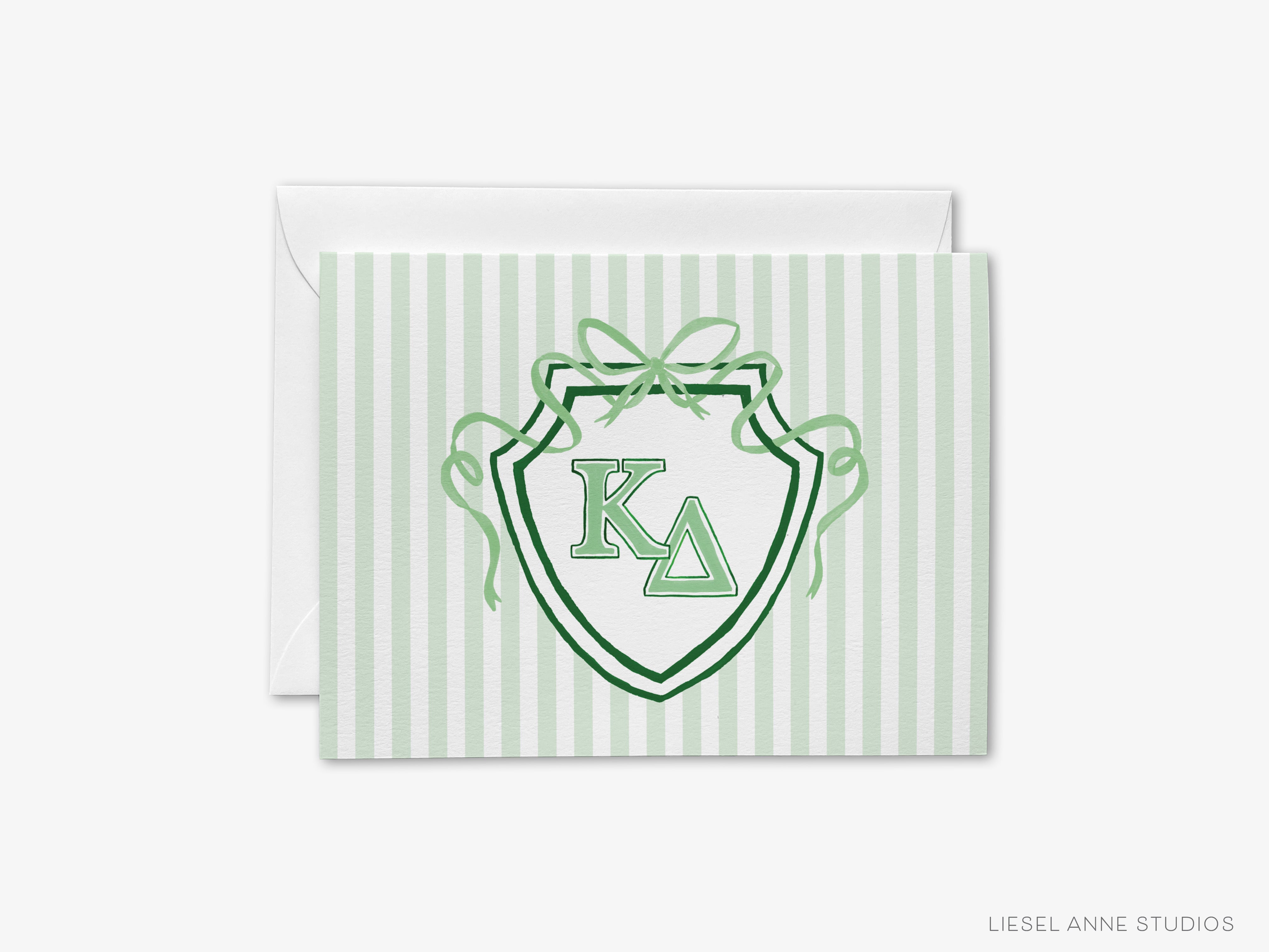 A greeting card with a green and white striped background and a shield-shaped emblem featuring the letters 'K' and 'Δ' in the center.