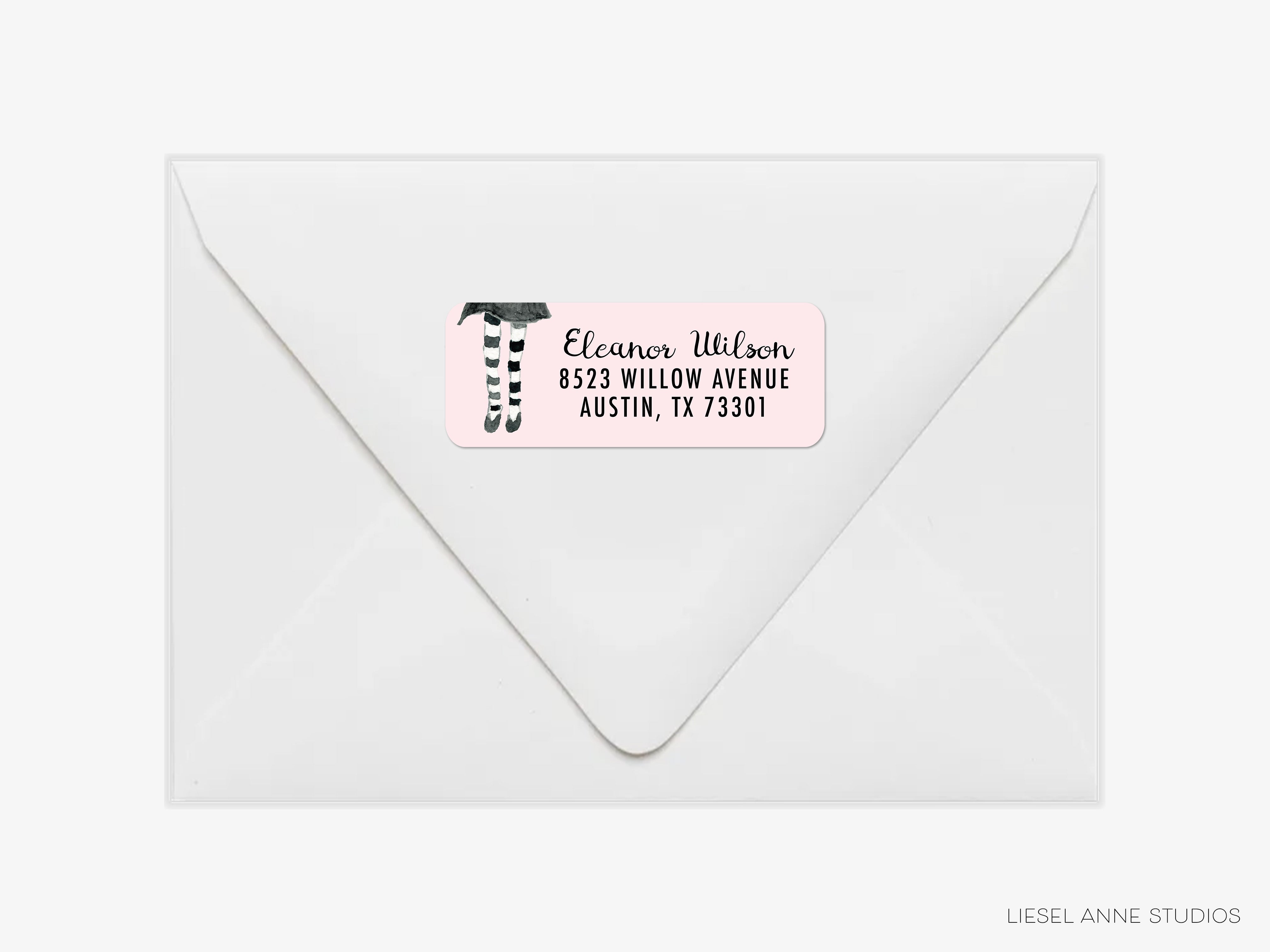 A white envelope with a pink label that reads "Ella Wilson" and "8323 Willow Avenue Austin, TX 7301".