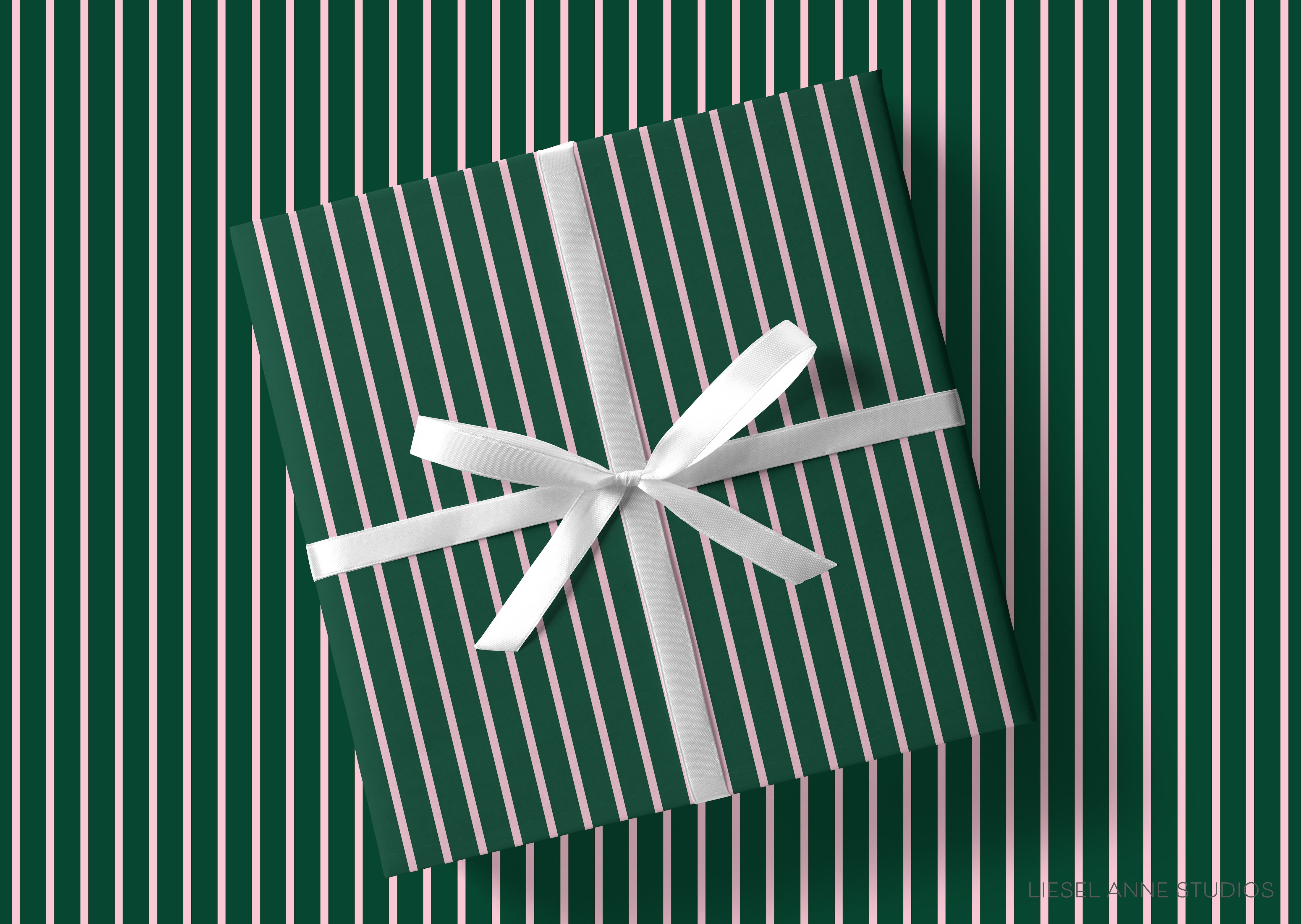 A green and white striped gift box with a white ribbon tied around it, placed on a striped background.