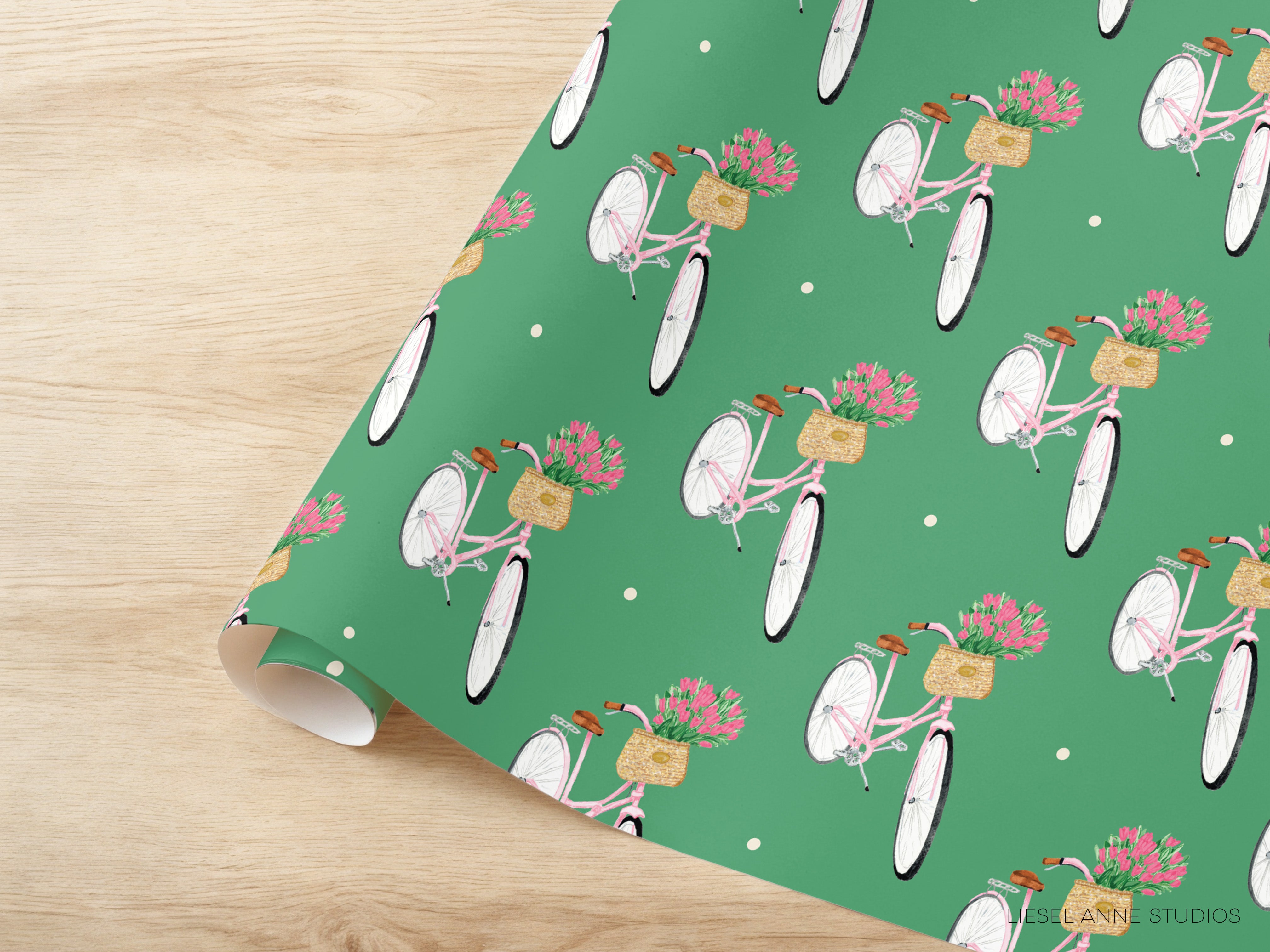a repeating pattern of pink bicycles with baskets of flowers on the handlebars, set against a green background with white polka dots.