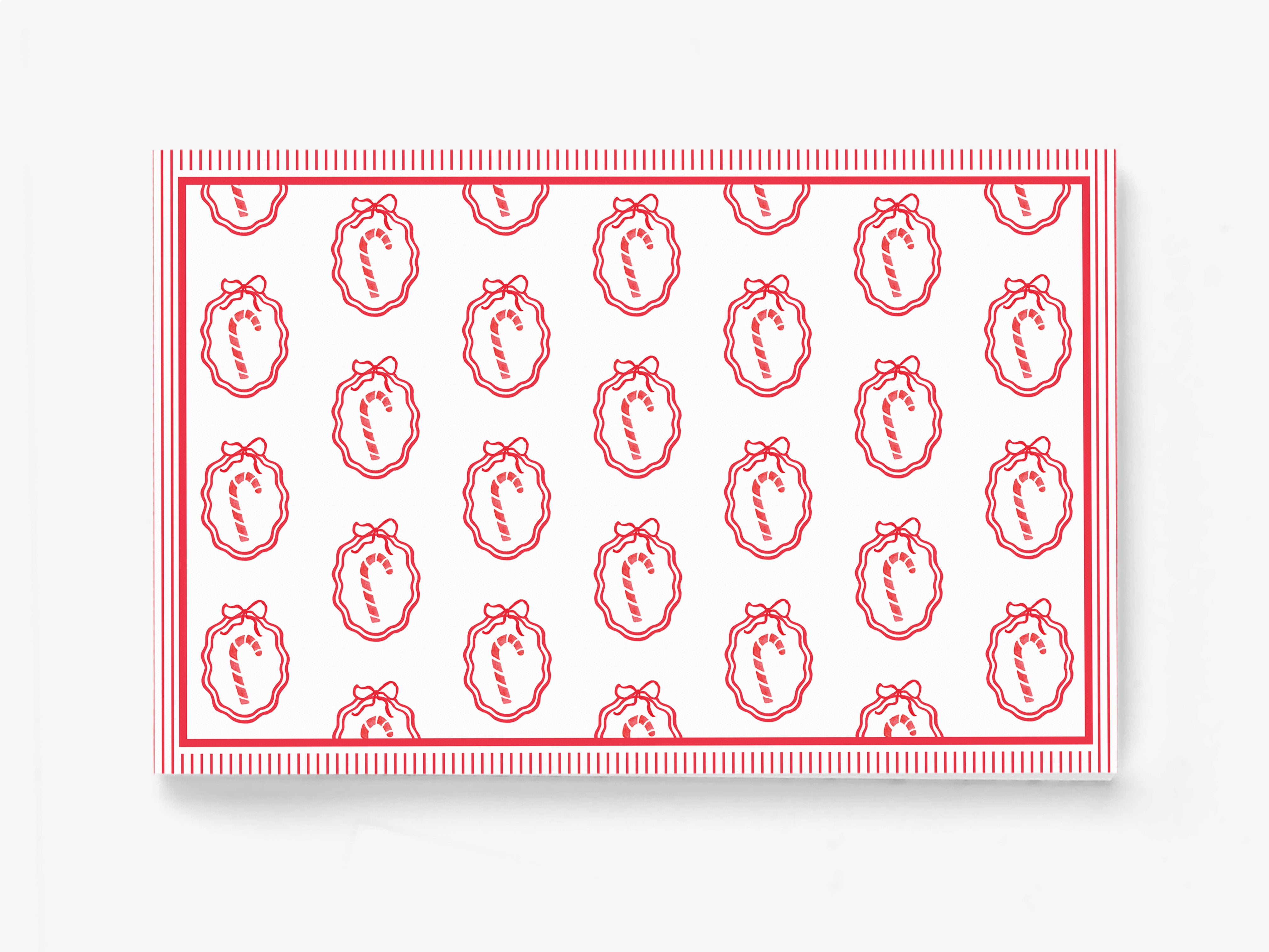 a repeating pattern of red and white candy canes with bows on a white background.