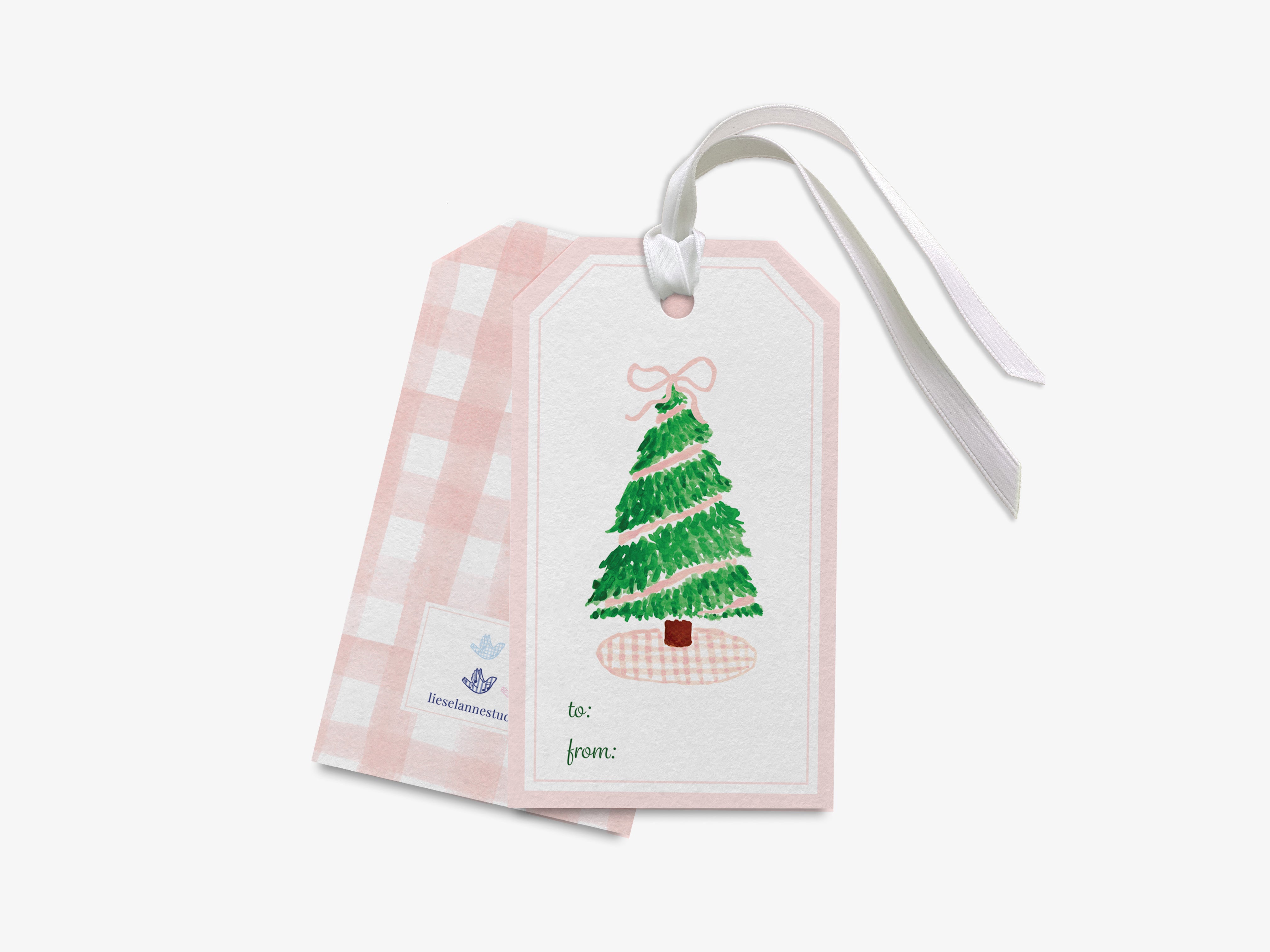 A pink and white Christmas tree gift tag with a white ribbon attached, featuring a green Christmas tree illustration.