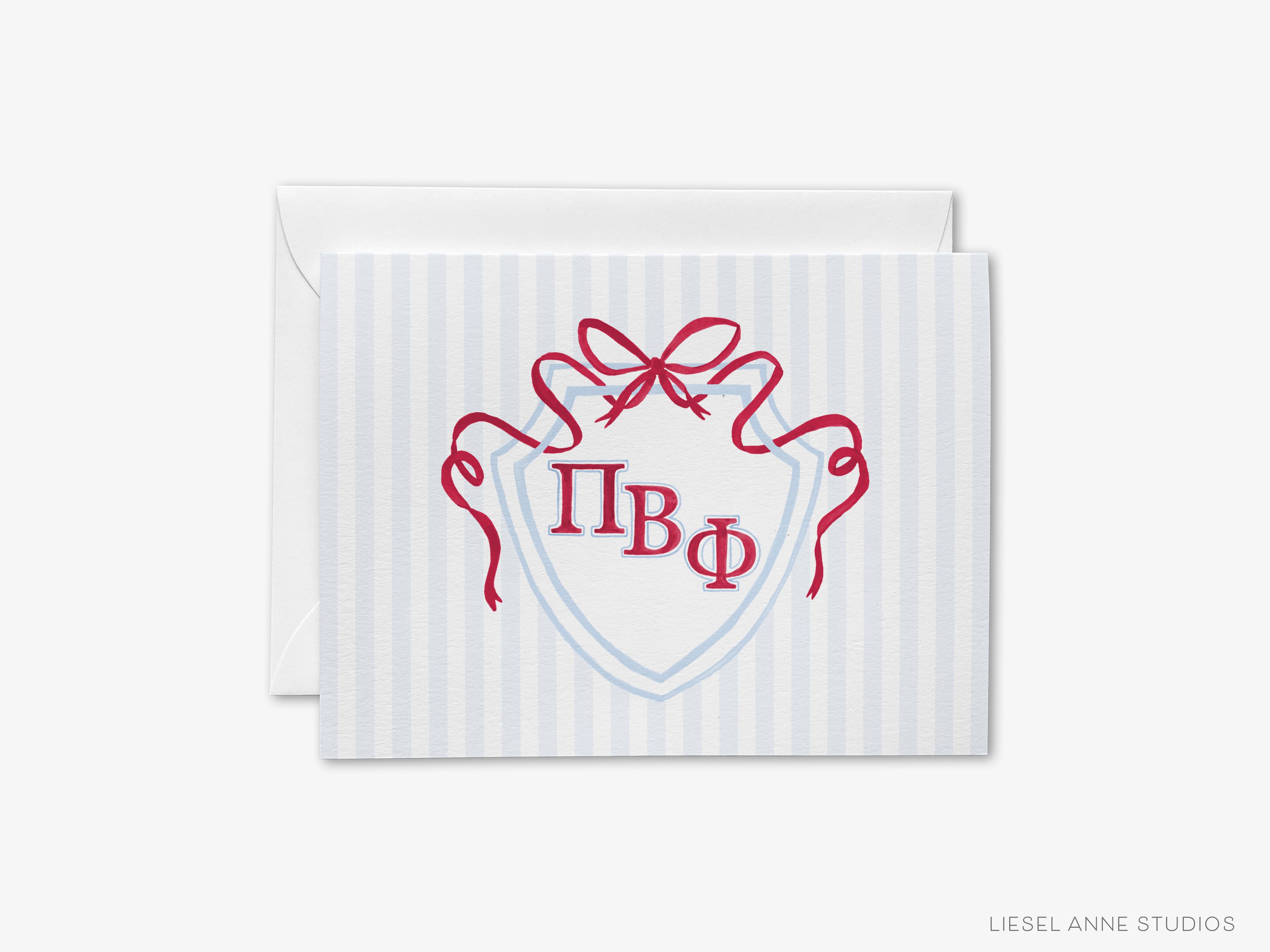 A greeting card with a shield-shaped design featuring the Greek letters "ΦΦΦ" and a red ribbon.