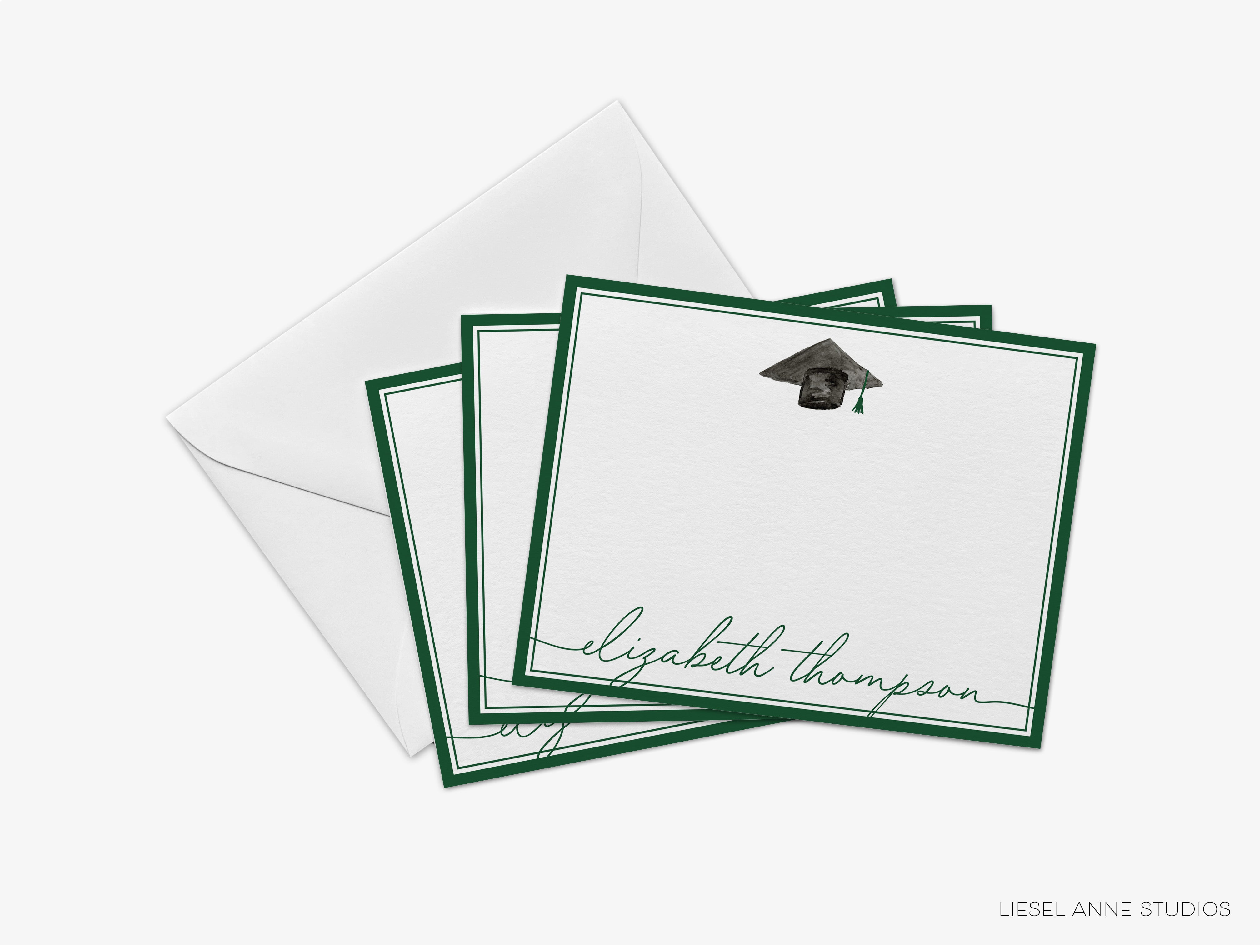 A set of personalized graduation cards with a graduation cap and mortarboard on the front, and an envelope on top.