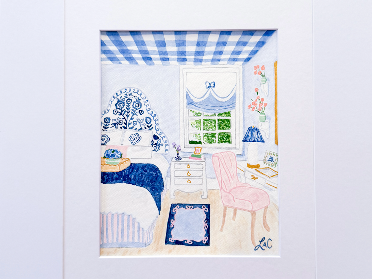 a bedroom with a blue and white checkered ceiling, a pink chair, a white dresser, a blue and white floral bedspread, and a window with a blue curtain.