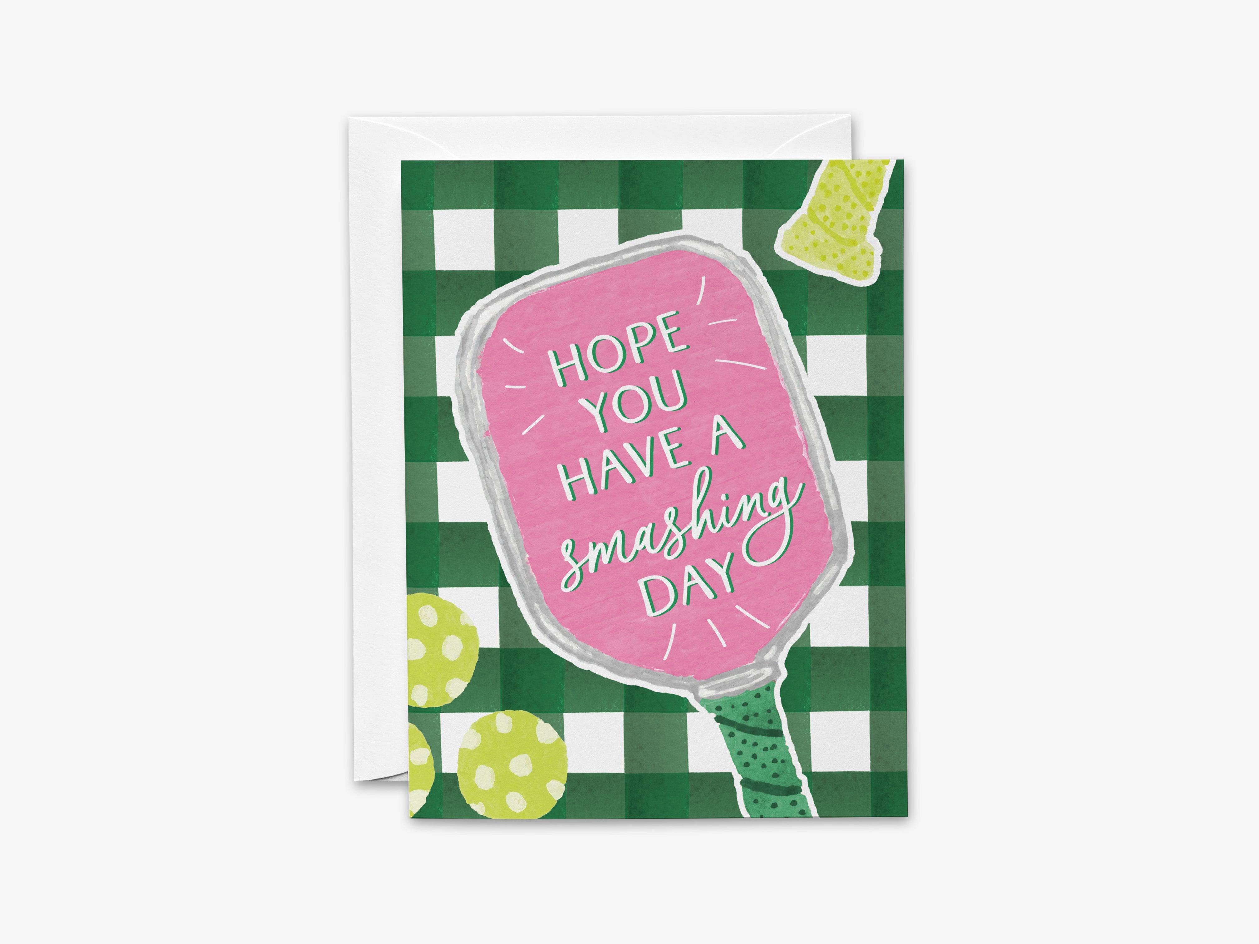 The image is a greeting card with a pink paddle and a green and white checkered background. The card has a message that says "Hope you have a smashing day".