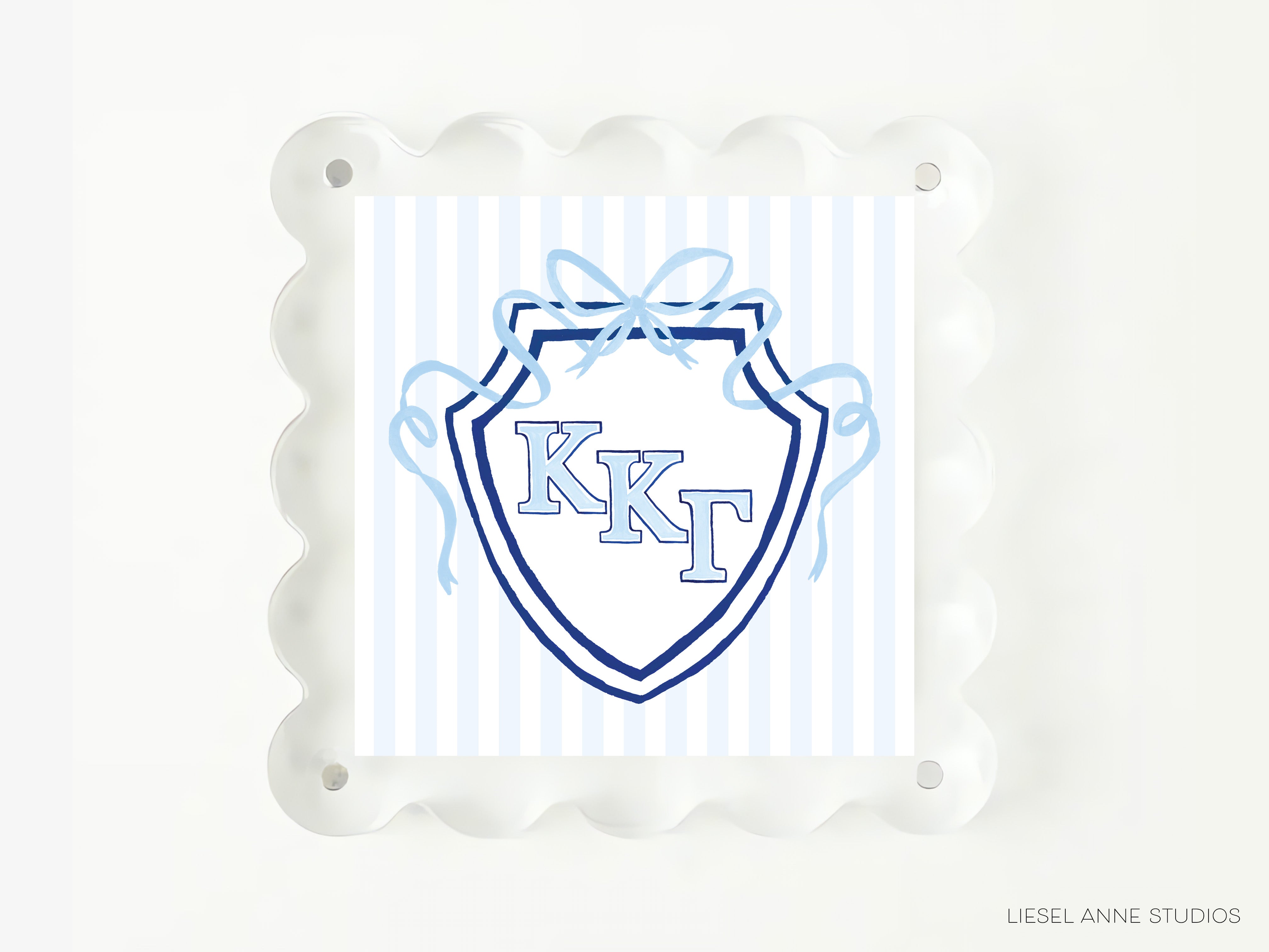A square image with a blue and white shield design featuring the letters 'KKT' in the center, surrounded by a decorative border.