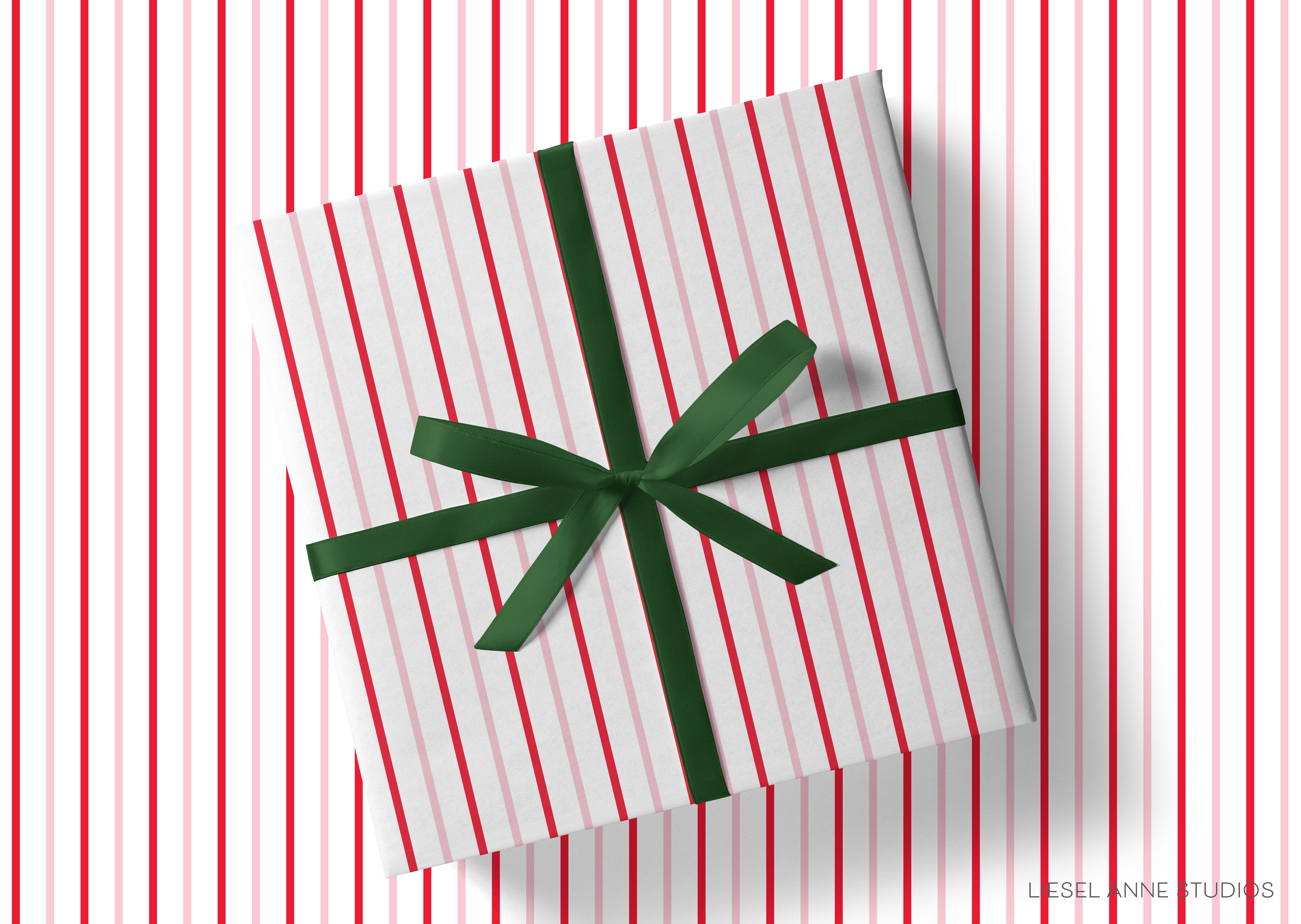 A gift box with a green ribbon tied around it, placed on a background of red and white striped vertical lines.