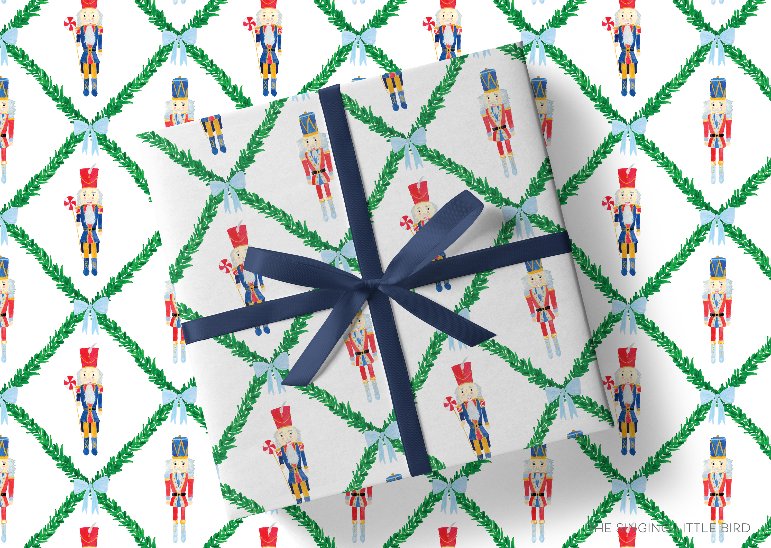 a gift wrapped in a pattern of nutcracker-themed wrapping paper with green leaves and a blue ribbon.