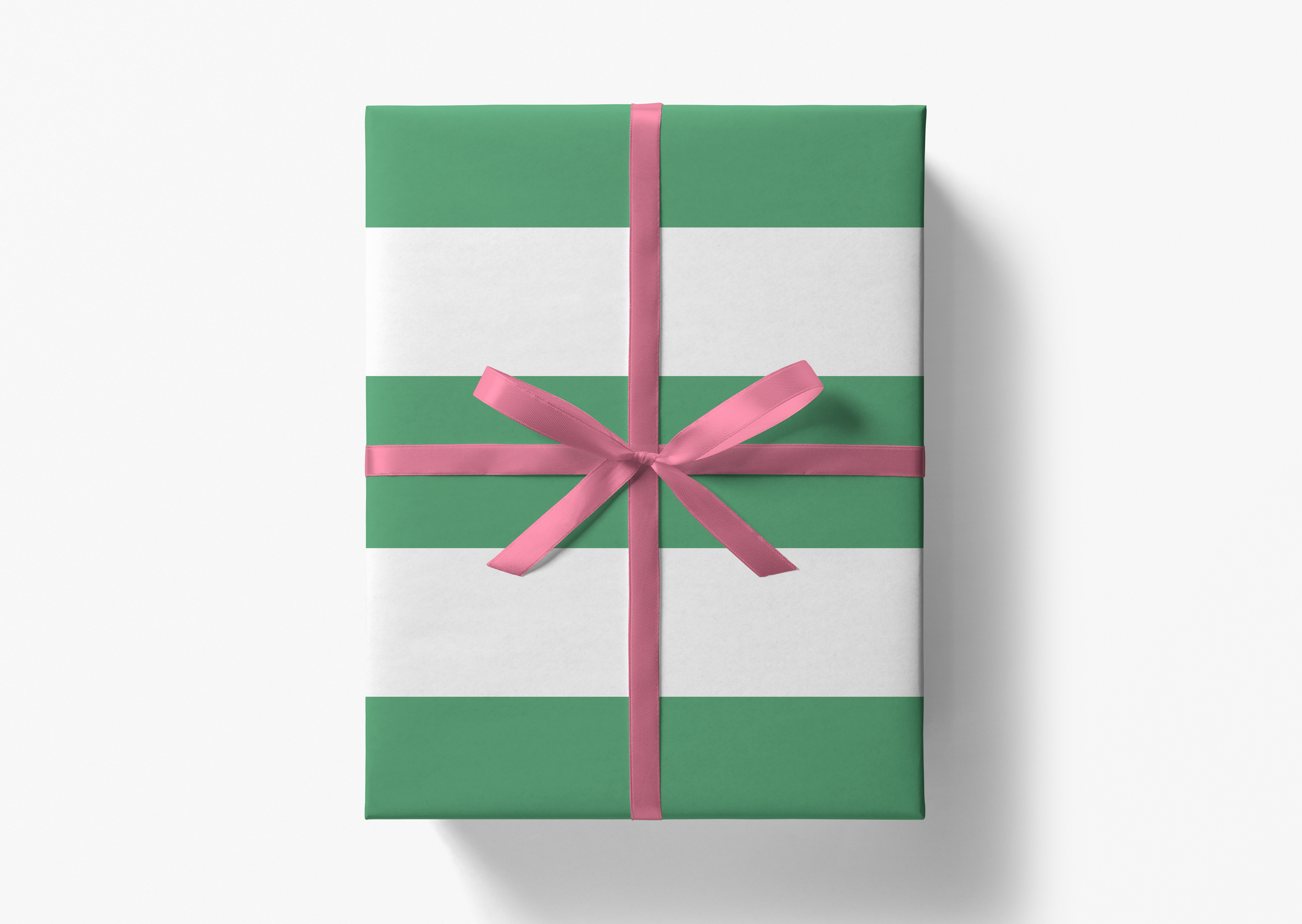 A green and white gift box with a pink ribbon tied around it.