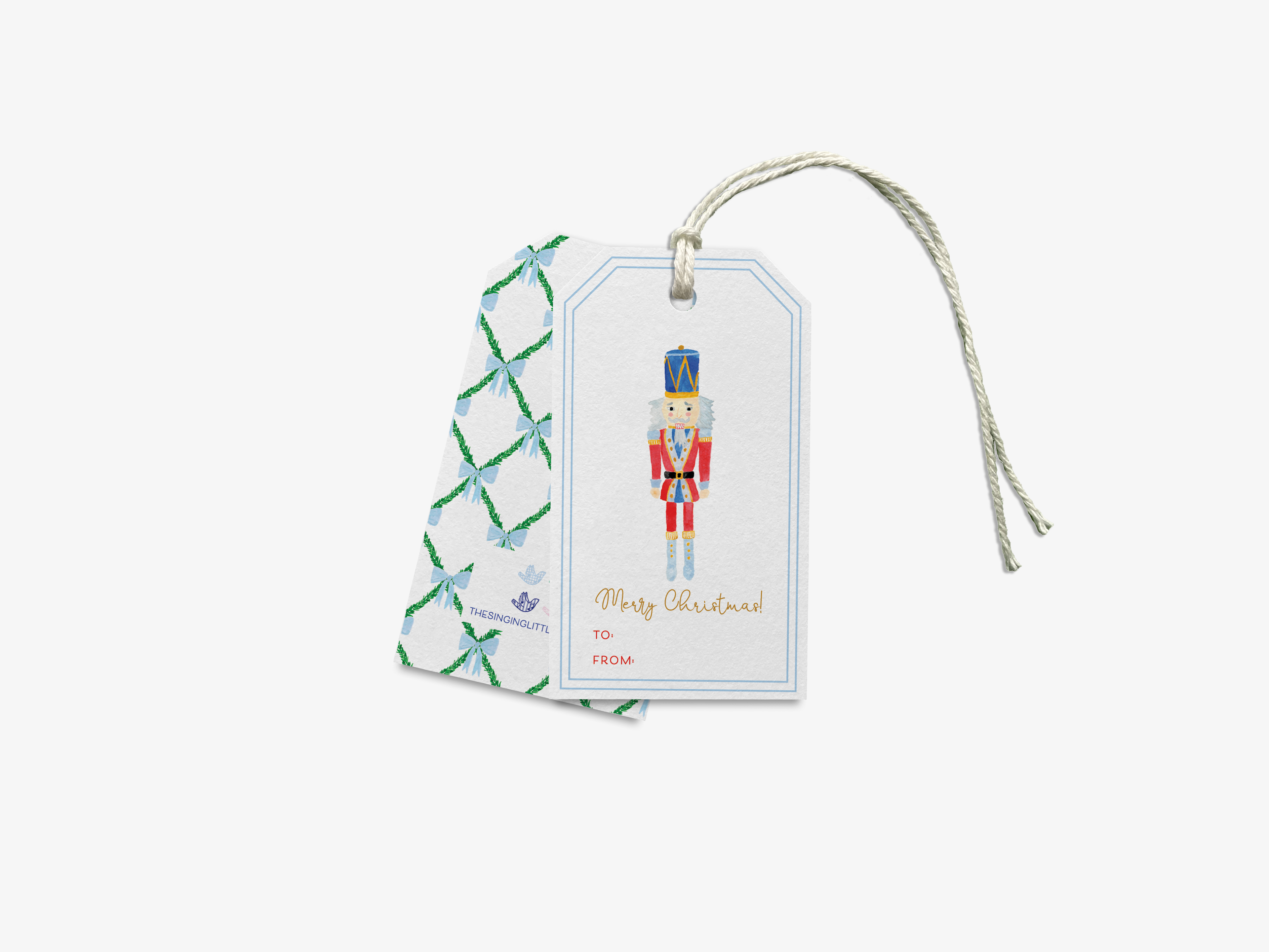 A white gift tag with a nutcracker figure and the text "Merry Christmas!" printed on it.