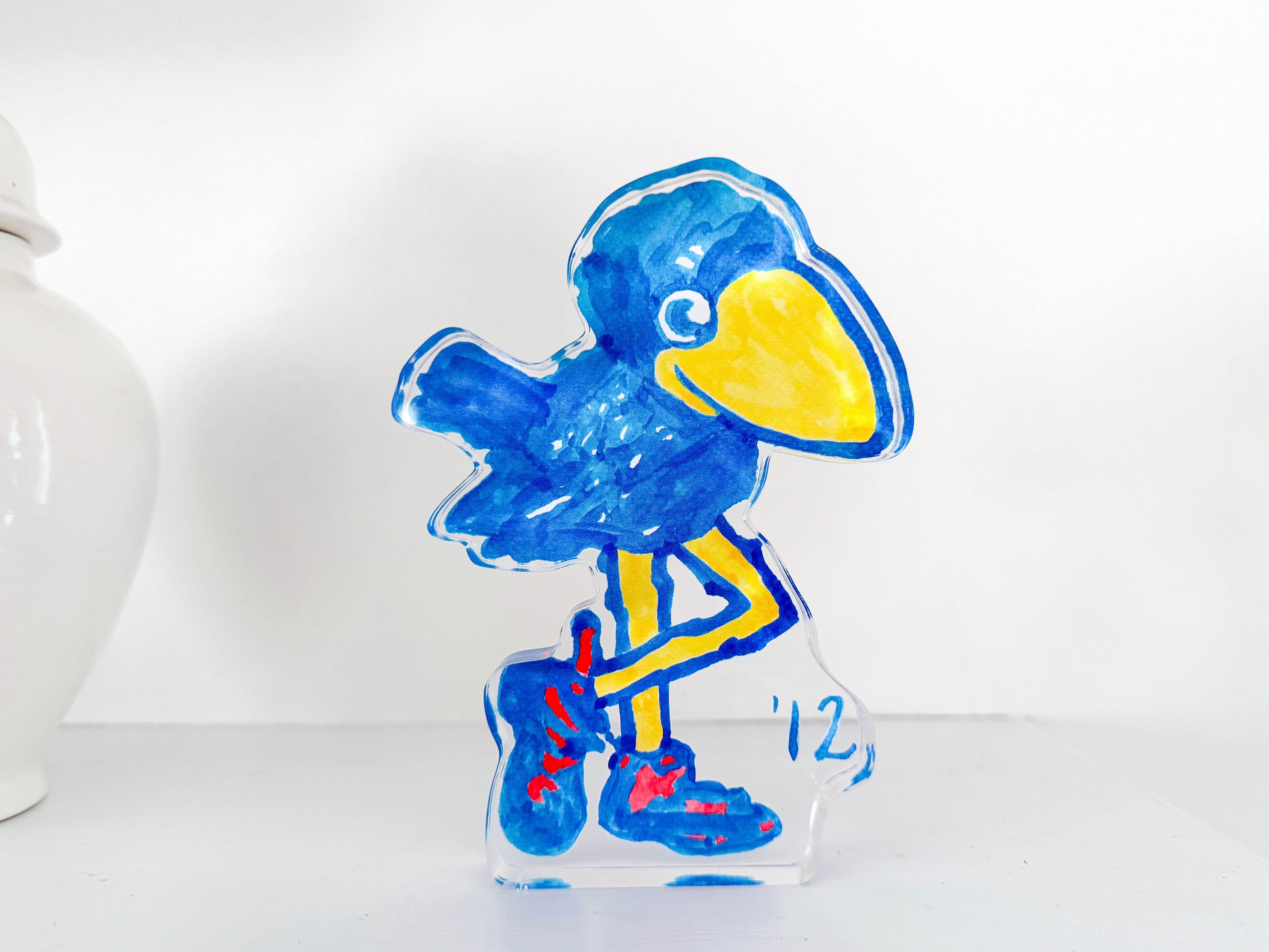 a drawing of a blue bird with a yellow beak