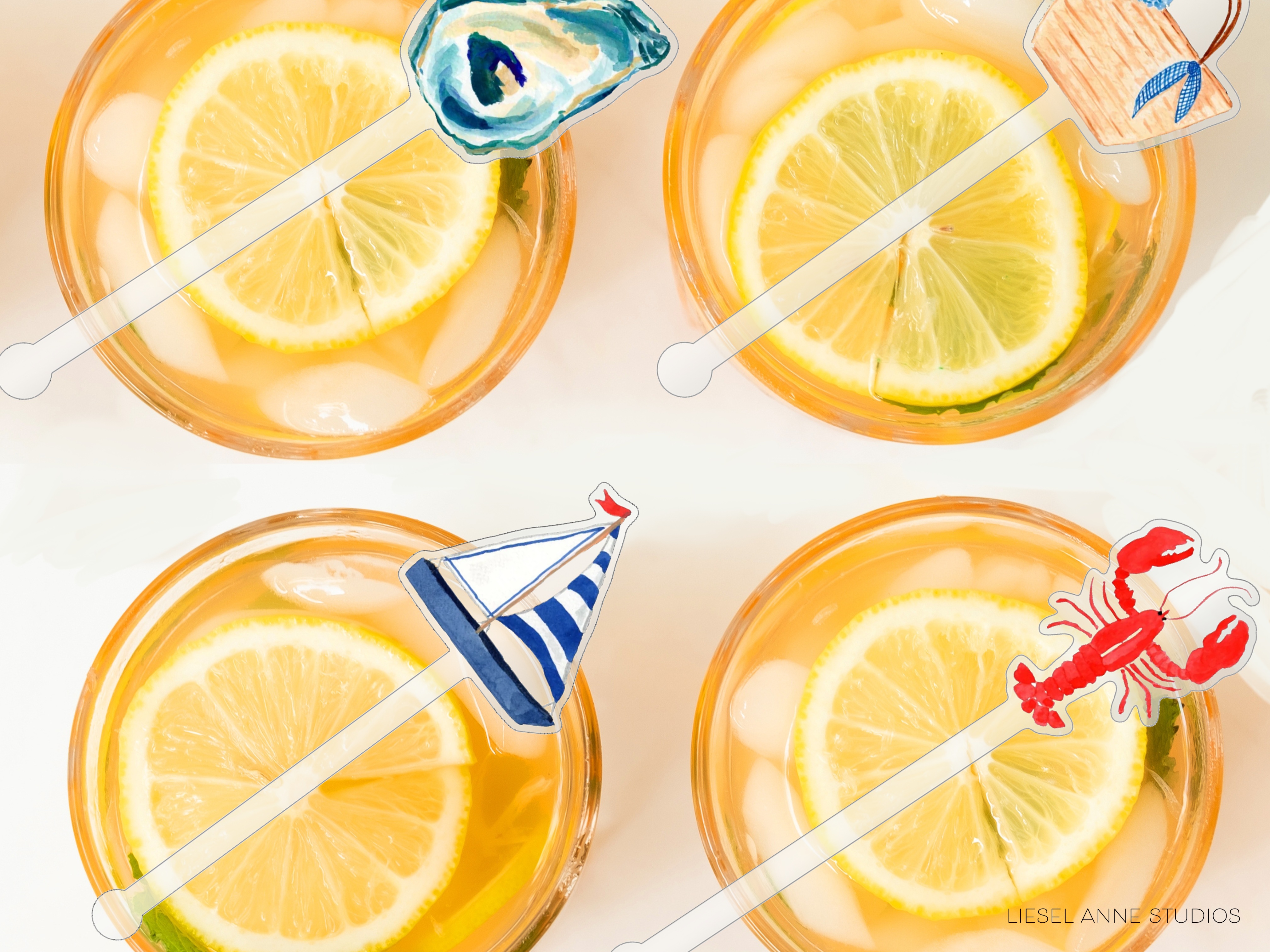 four glasses filled with a yellow liquid, each containing a slice of lemon and a small toy boat decoration.