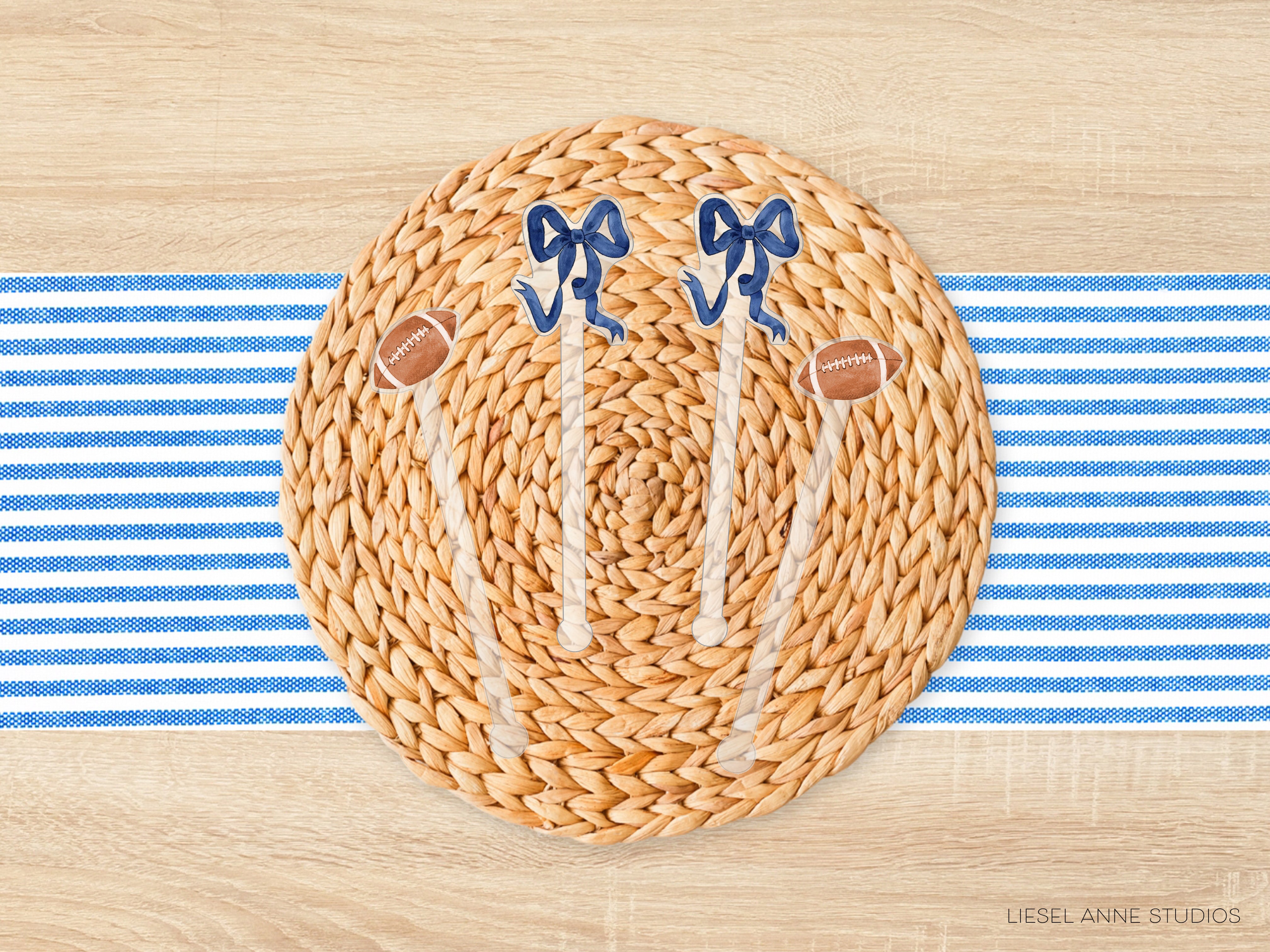 a woven placemat with a football motif, including two blue bows and two brown footballs, placed on a blue and white striped tablecloth.
