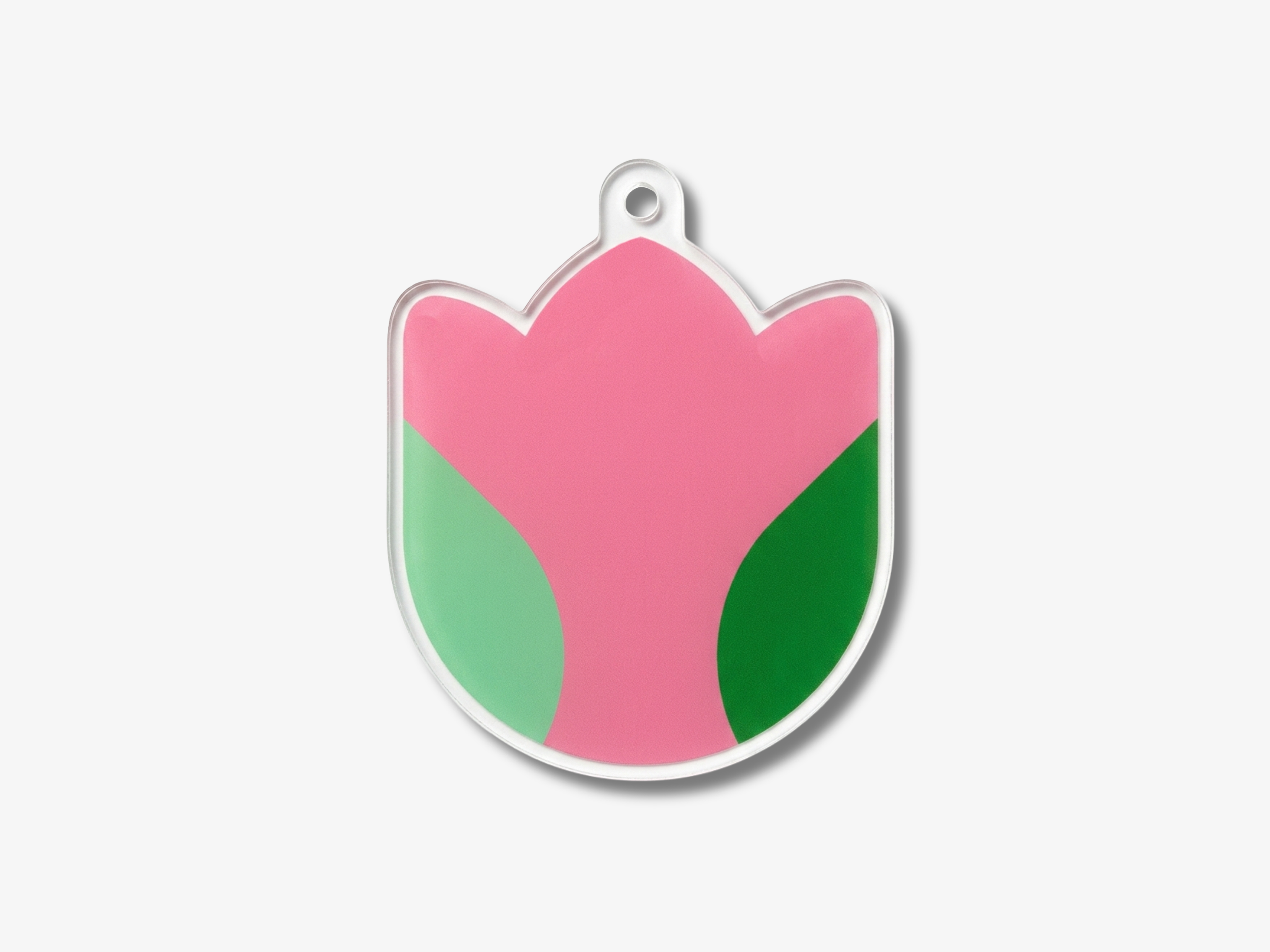 A pink and green flower-shaped pendant with a clear plastic design.
