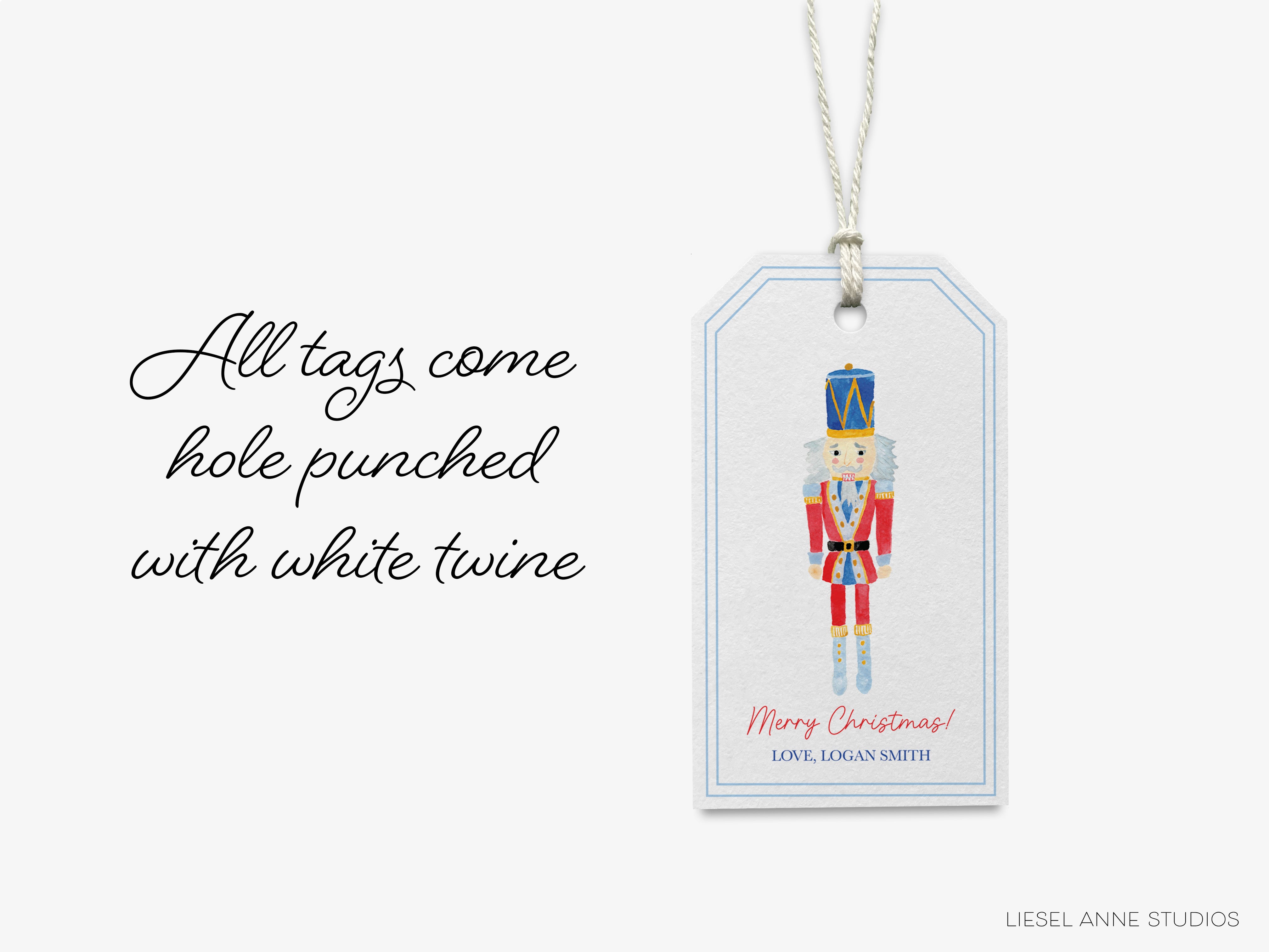 A white tag with a nutcracker figure and the text "Merry Christmas! LOVE LOGAN SMITH" printed on it.