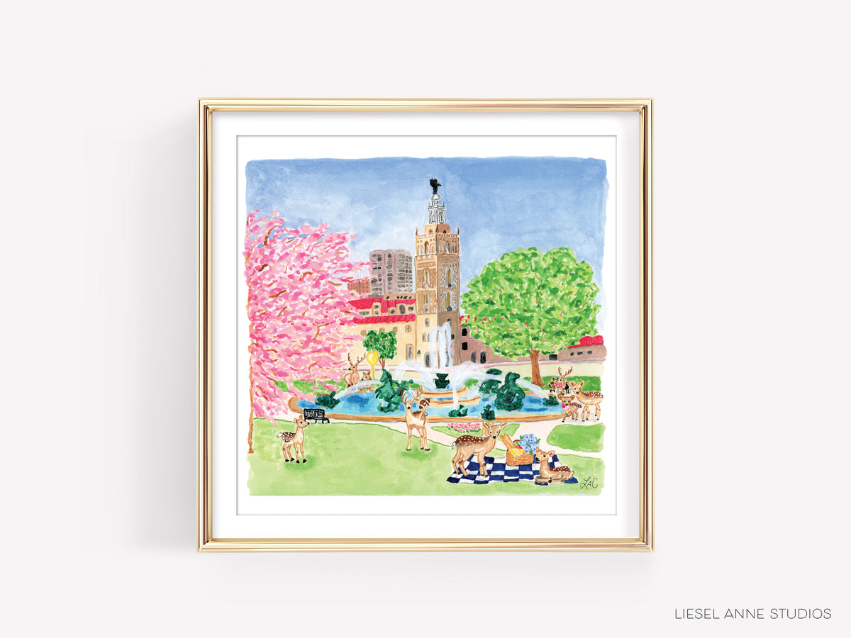 A framed watercolor painting depicting a park scene with a tall tower, pink flowers, and animals in the foreground.