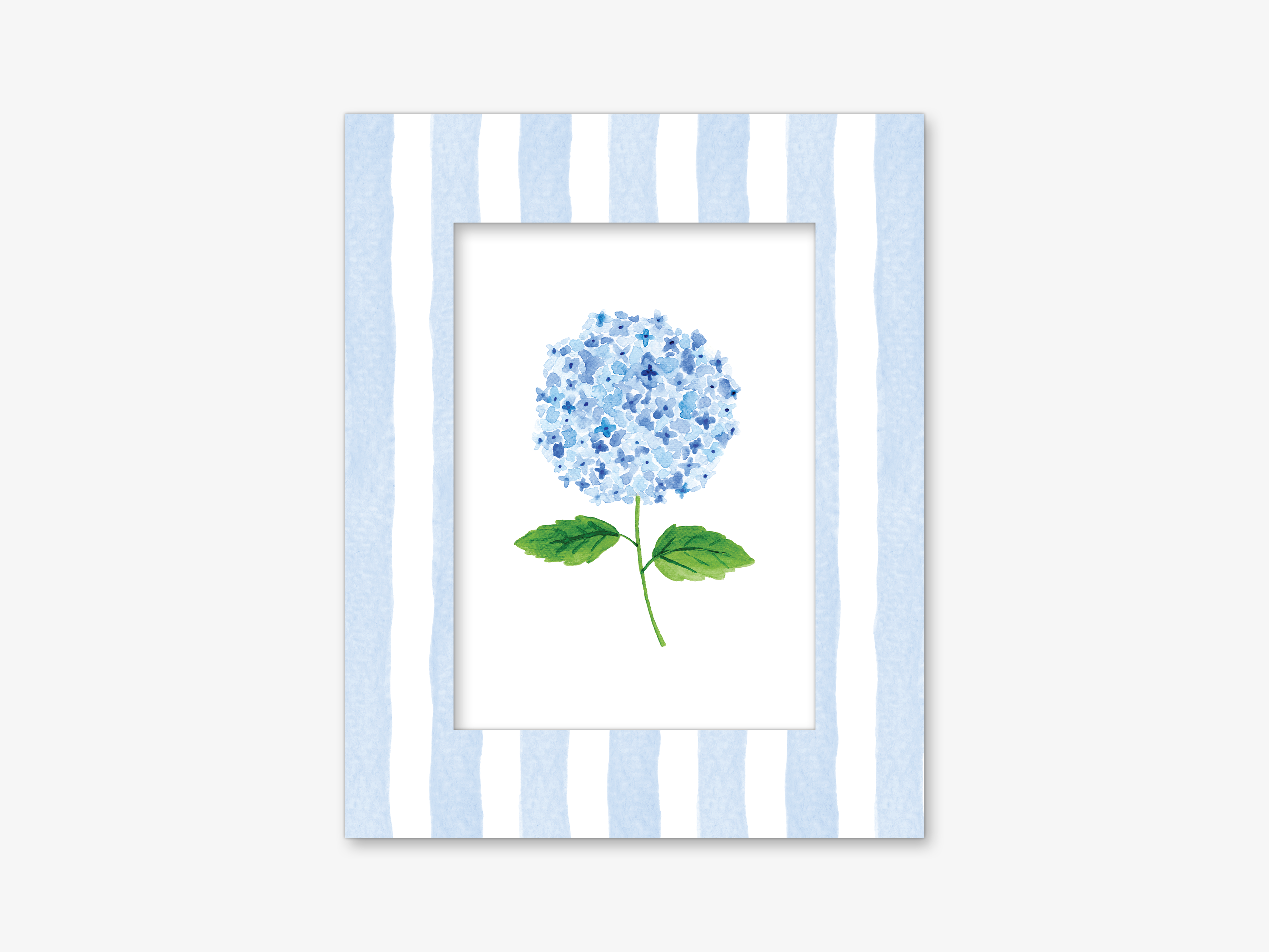 A framed watercolor painting of a blue hydrangea flower with green leaves.