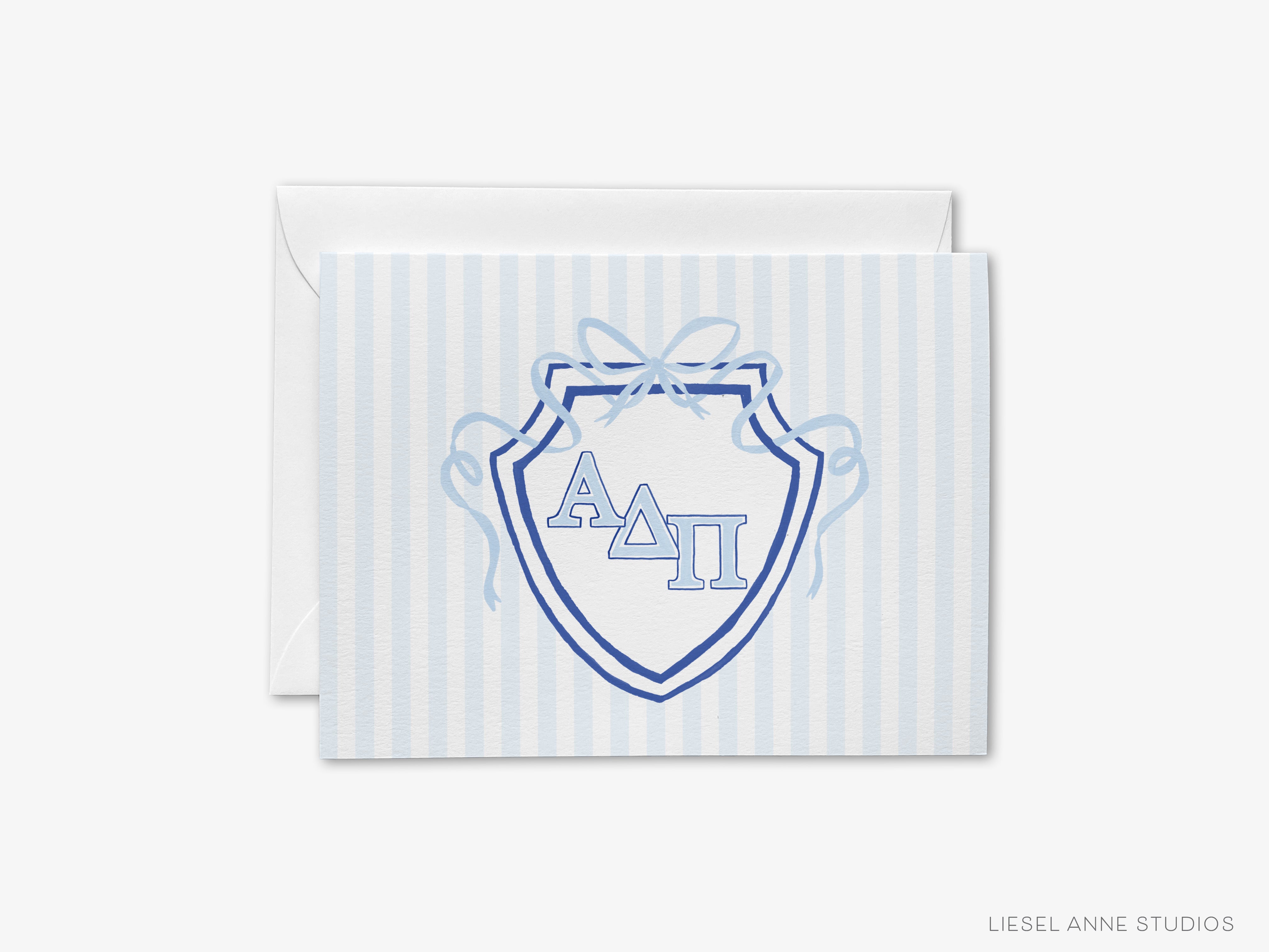 A greeting card with a shield-shaped design featuring the letters 'ΑΓΟΡΕΙΚΗ' (Delta Phi) in the center, surrounded by a blue ribbon.