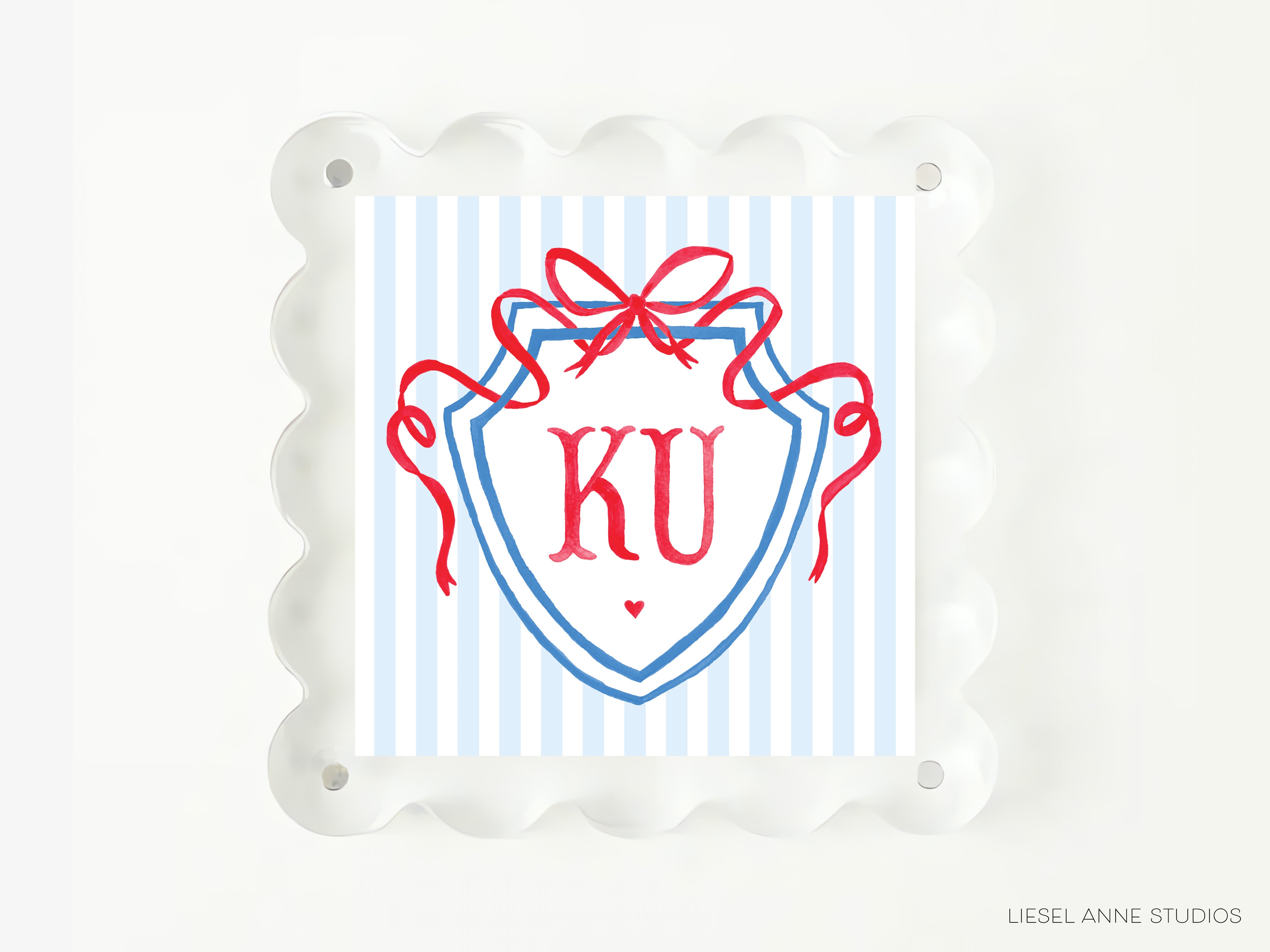 A square image with a blue and white striped background, featuring a shield-shaped design with a red ribbon and the letters 'KU' prominently displayed.