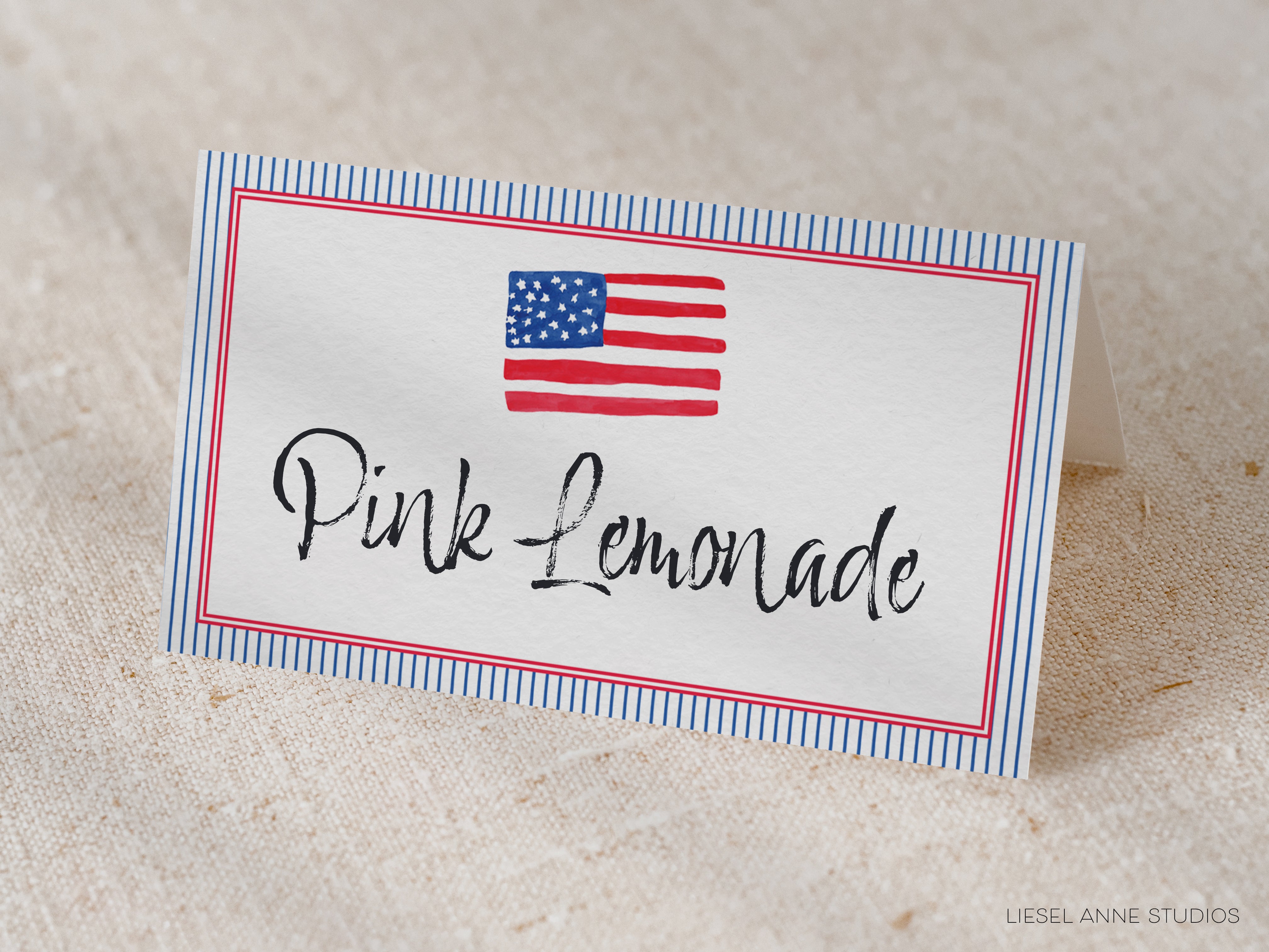 A white card with a blue border and an American flag design, displaying the text "Pink Lemonade" in a cursive font.