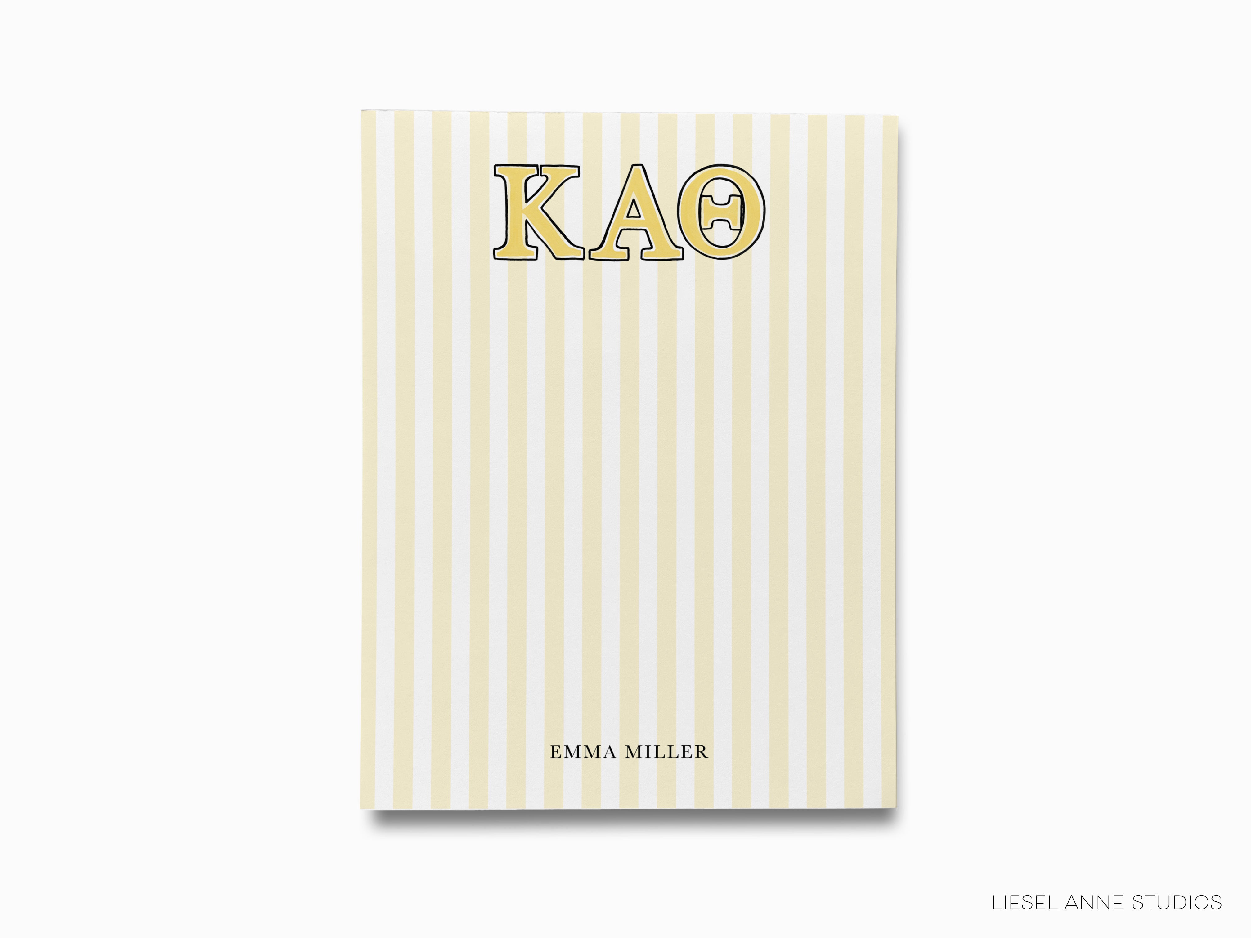 a yellow and white striped notebook with the word kao on it