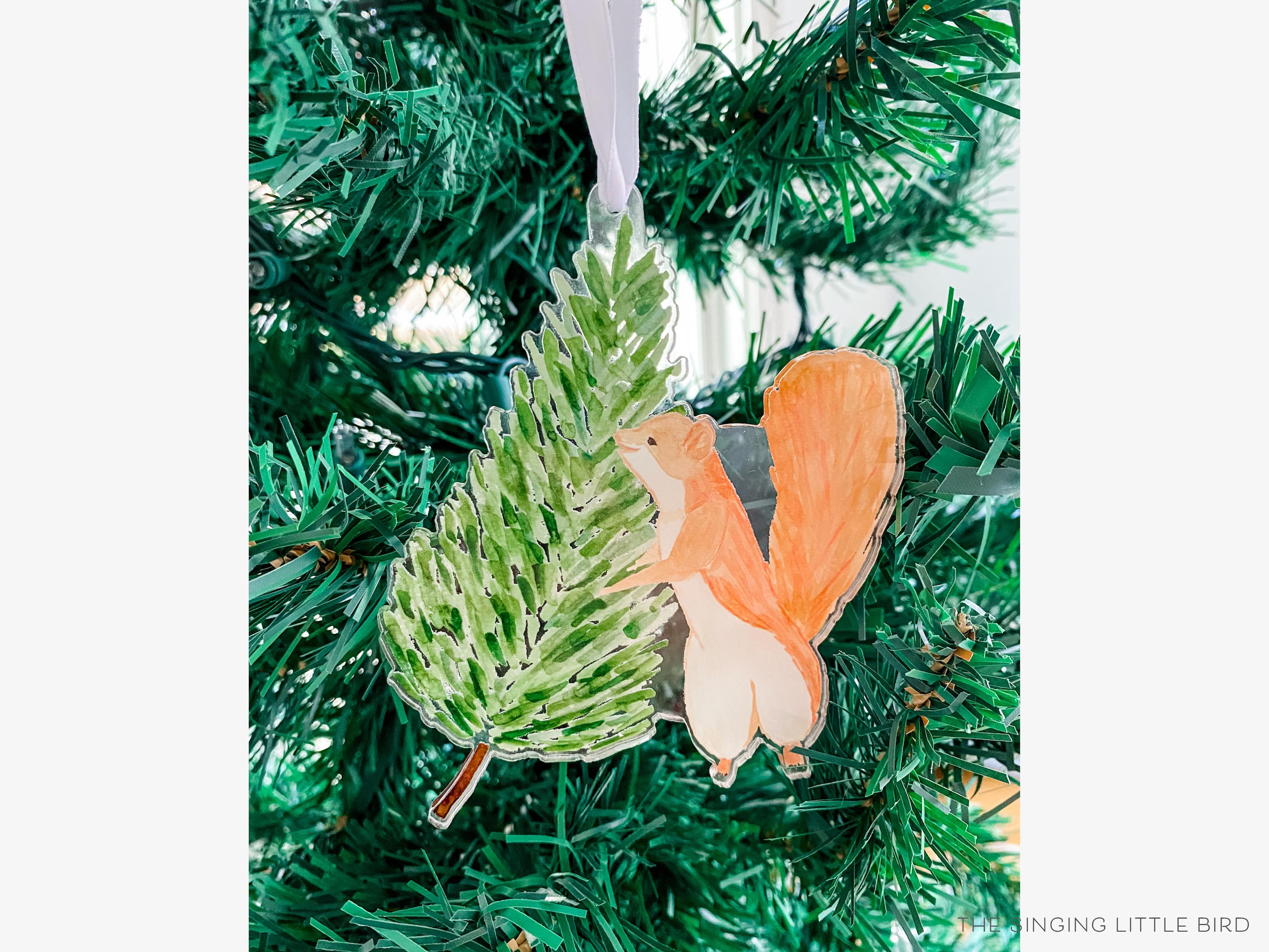 Earl The Tree Squirrel Acrylic Ornament-These acrylic ornaments feature our hand-painted watercolor squirrel and evergreen tree. They include a white silk ribbon and measure approximately 4" on its longest side, making a great addition to your Christmas tree or gift for the animal lover in your life.-The Singing Little Bird