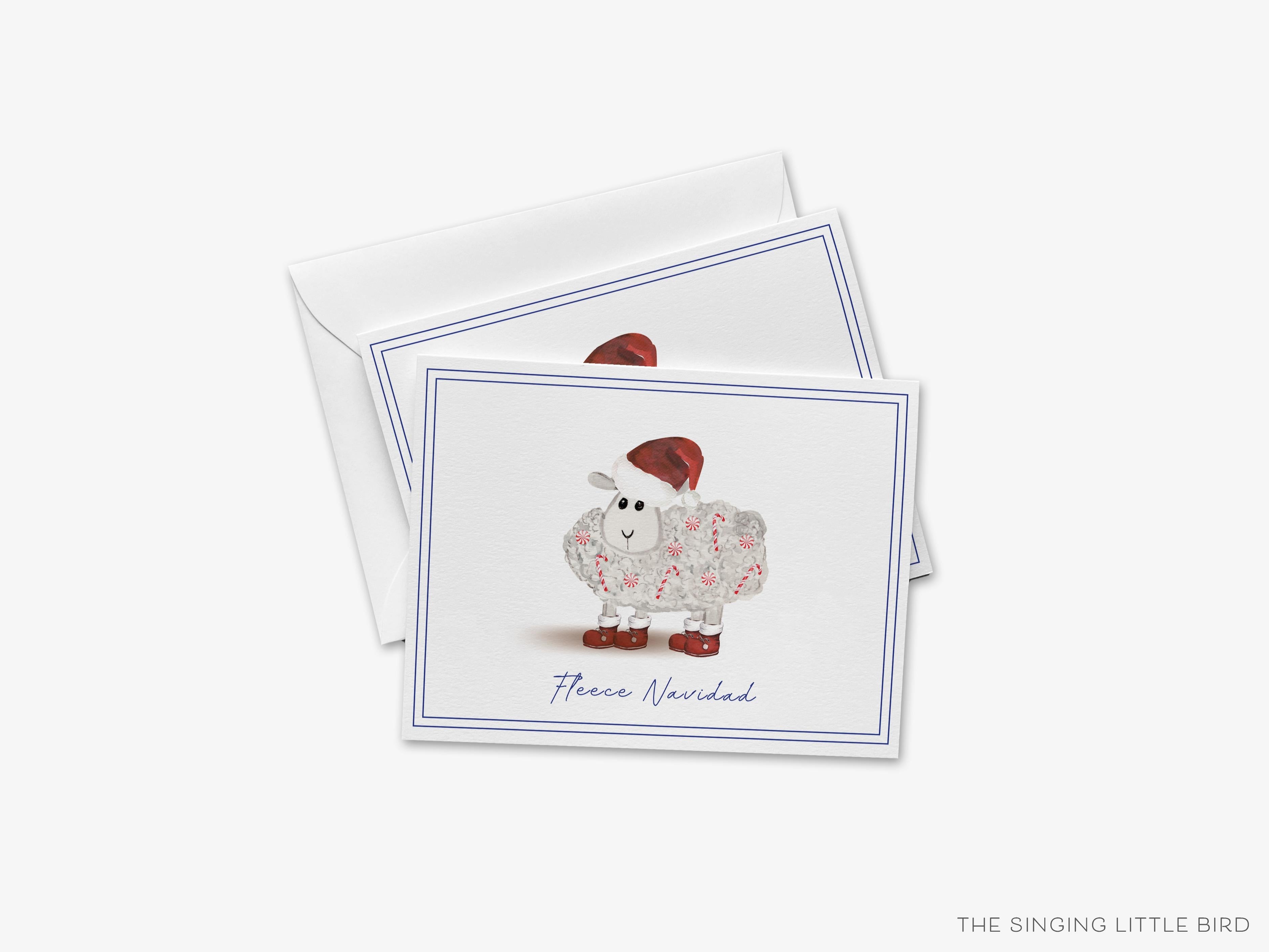 Fleece Navidad Christmas Card-These folded greeting cards are 4.25x5.5 and feature our hand-painted sheep with Santa hat and candy canes, printed in the USA on 100lb textured stock. They come with a White envelope and make a great happy holidays card for the holiday pun lover in your life.-The Singing Little Bird