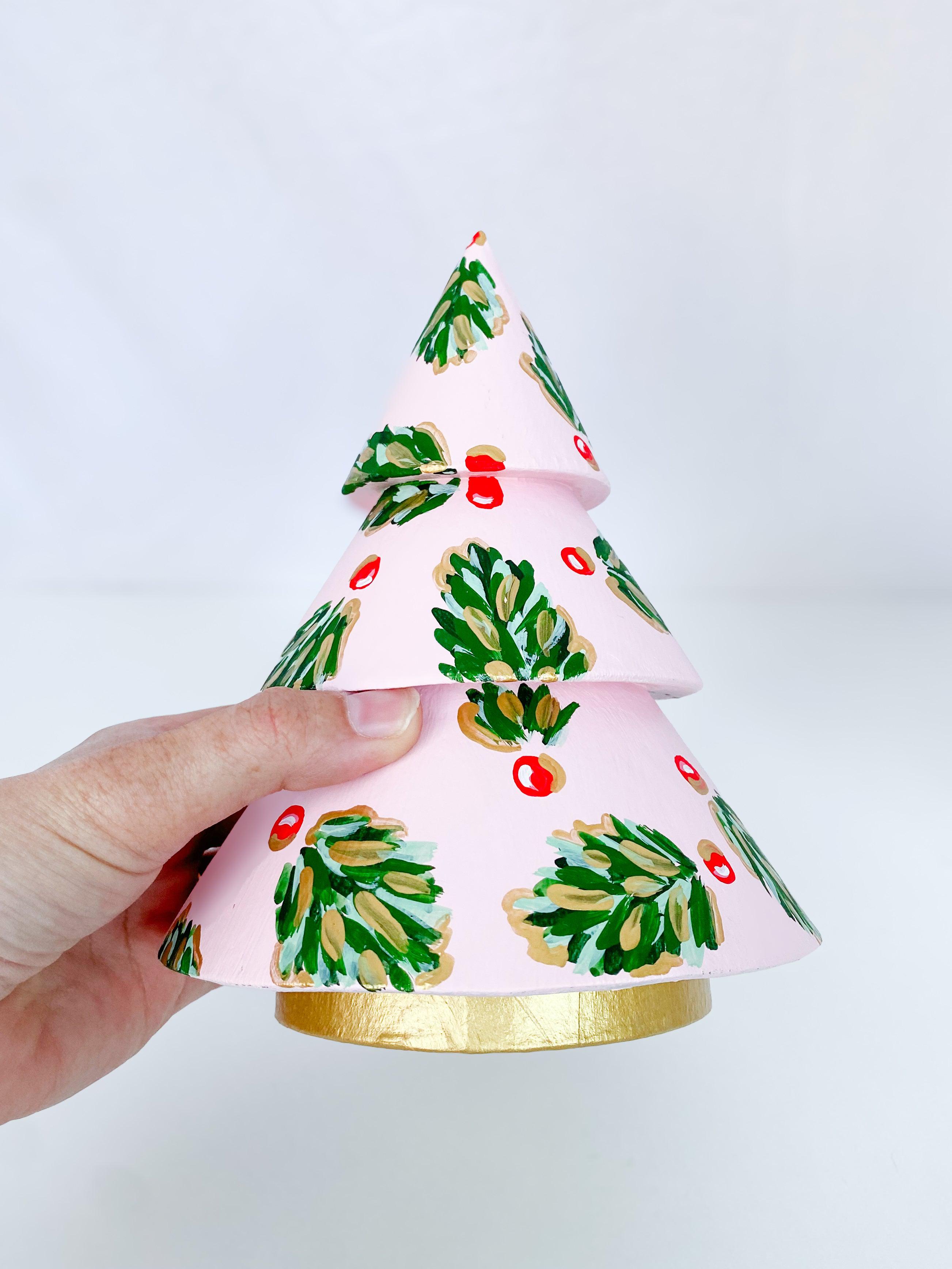 Frosty Pink Golden Holly Mini Tree - Short-Hand-Painted Mini Christmas Tree | Measures 7.5" tall and approx. 5.5" wide | Features the Golden Holly design with a pale pink base and shimmery gold accents and gold trunk | Light-weight and non-breakable paper mache tree | Coated with a protective matte finish that will keep it shimmering year after year | Each tree is slightly different with potential small imperfections due to the hand-painted nature, making each one special and unique!-The Singing Little Bird