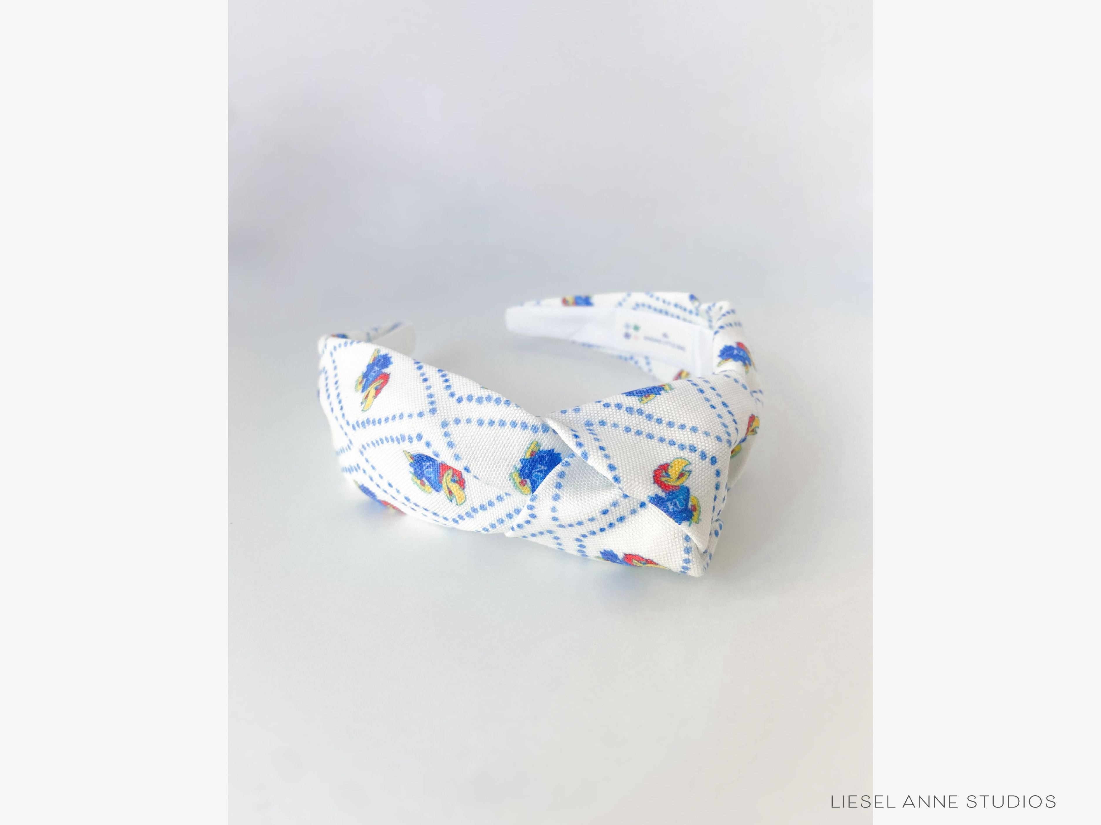 Jayhawk Officially Licensed Blue and White Dotted Diamond Headband-These fabric headbands make unique one-of-a-kind gifts as each one is slightly different. They are cut from our hand-painted signature print. These are the perfect accessory and make great gifts!-The Singing Little Bird