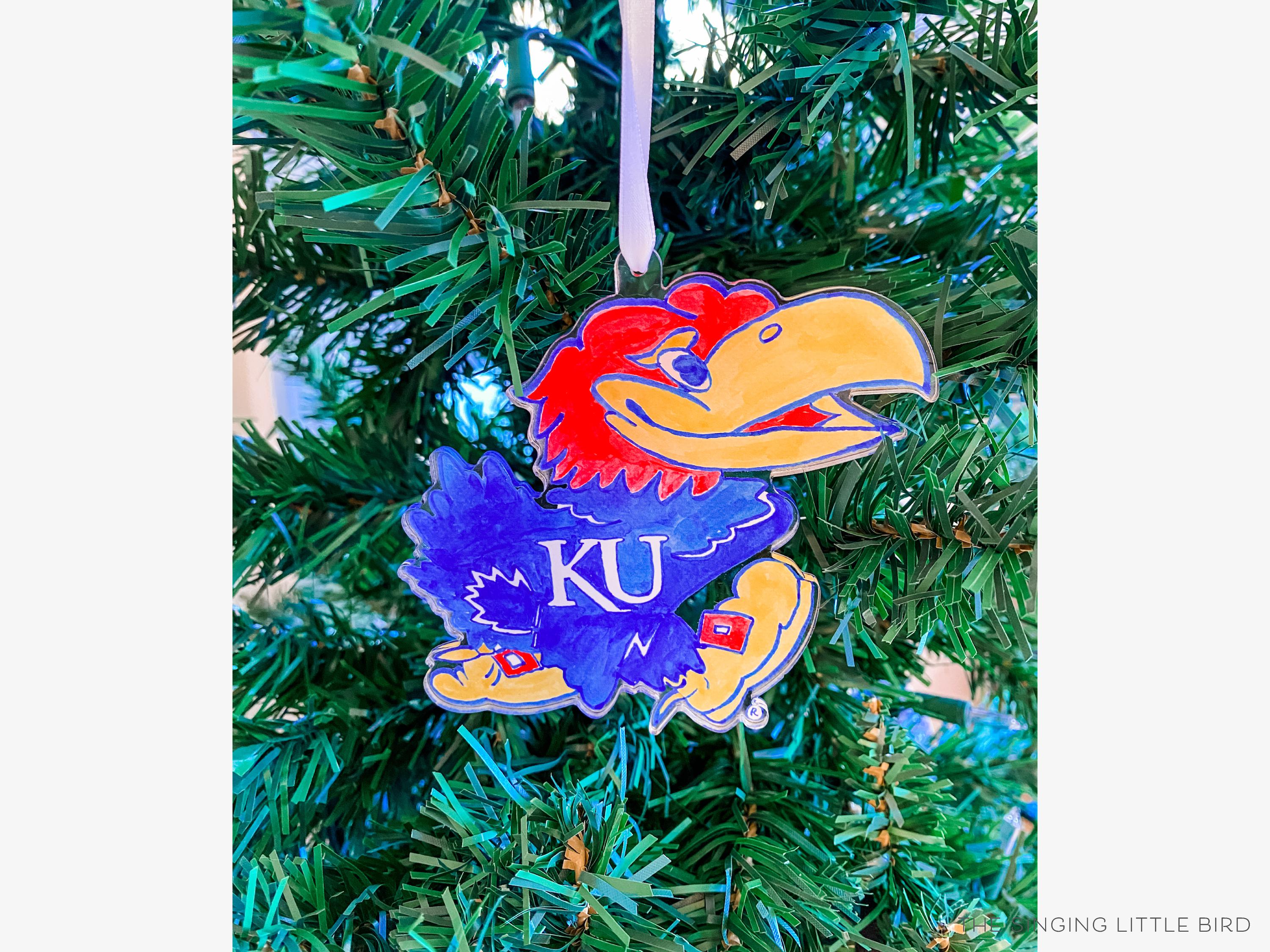 Kansas Jayhawk Acrylic Ornament [Officially Licensed]-These acrylic ornaments feature our hand-painted watercolor Kansas Jayhawk. They include a white silk ribbon and measure approximately 4" on its longest side, making a great addition to your Christmas tree or gift for the University of Kansas lover in your life.-The Singing Little Bird