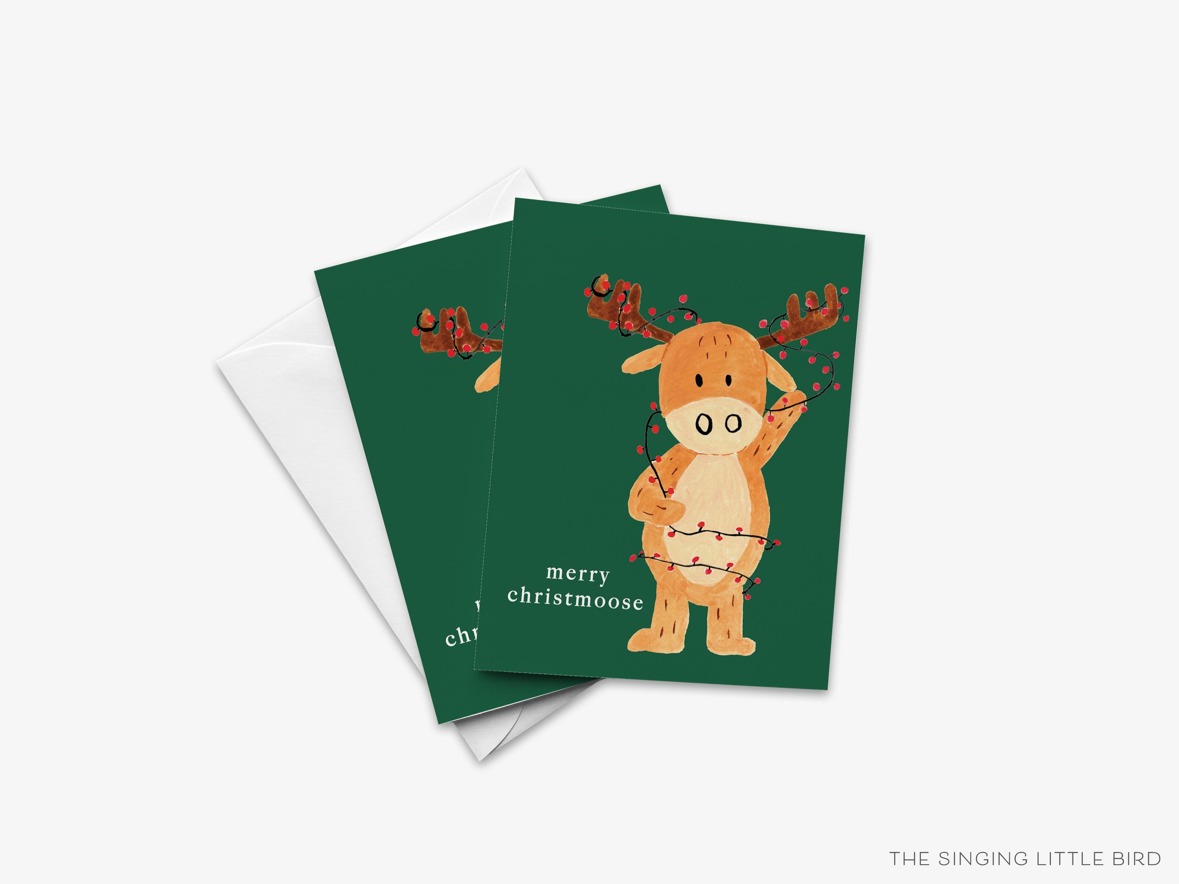 Merry Christmoose Christmas Pun Greeting Card-These folded greeting cards are 4.25x5.5 and feature our hand-painted moose and Christmas lights, printed in the USA on 100lb textured stock. They come with a White envelope and make a great Christmas card for the animal and pun lover in your life.-The Singing Little Bird