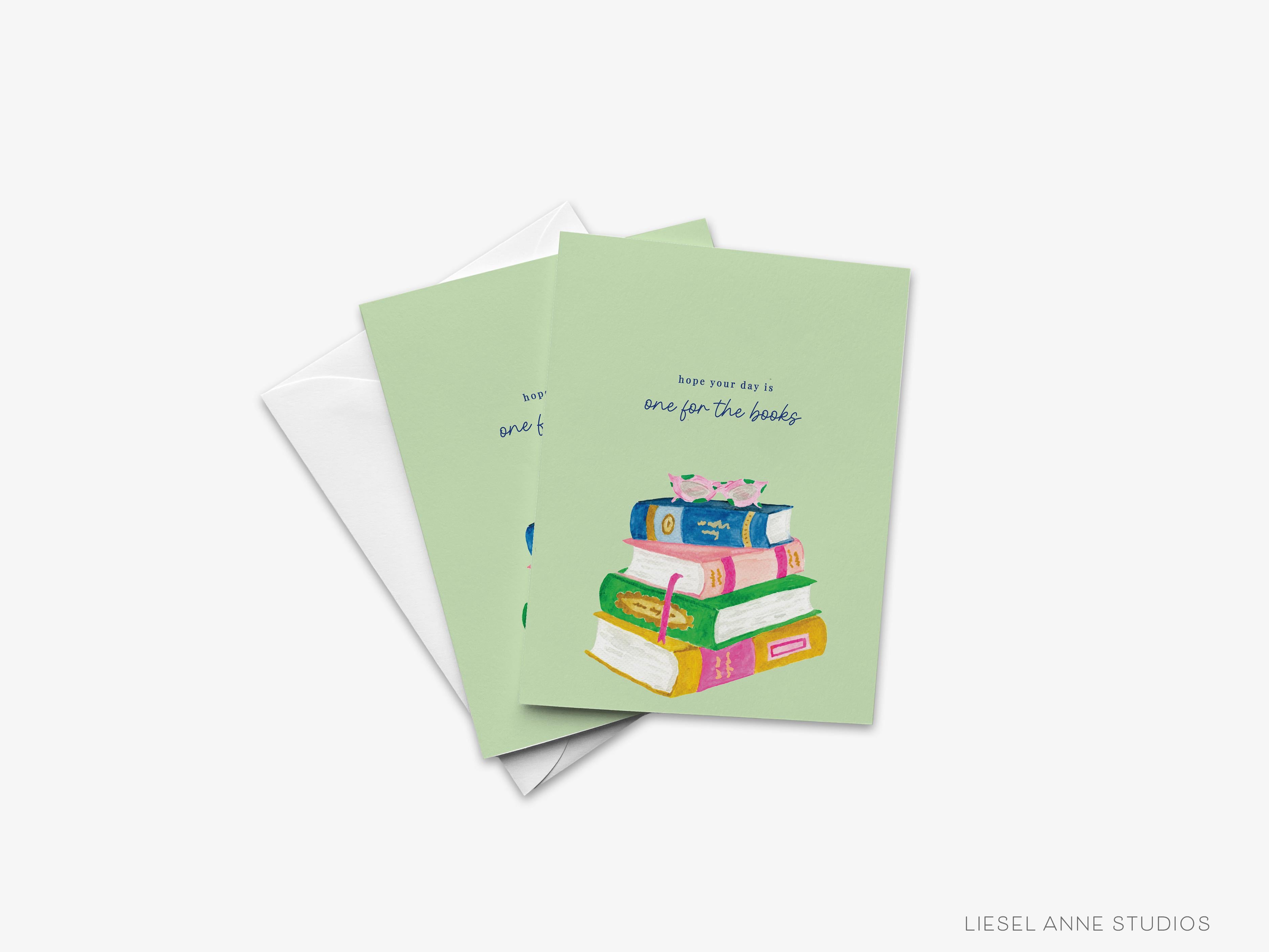 One For The Books Greeting Card-These folded cheers cards are 4.25x5.5 and feature our hand-painted watercolor bookstack, printed in the USA on 100lb textured stock. They come with a white envelope and make a thoughtful birthday card for a family member or friend.-The Singing Little Bird