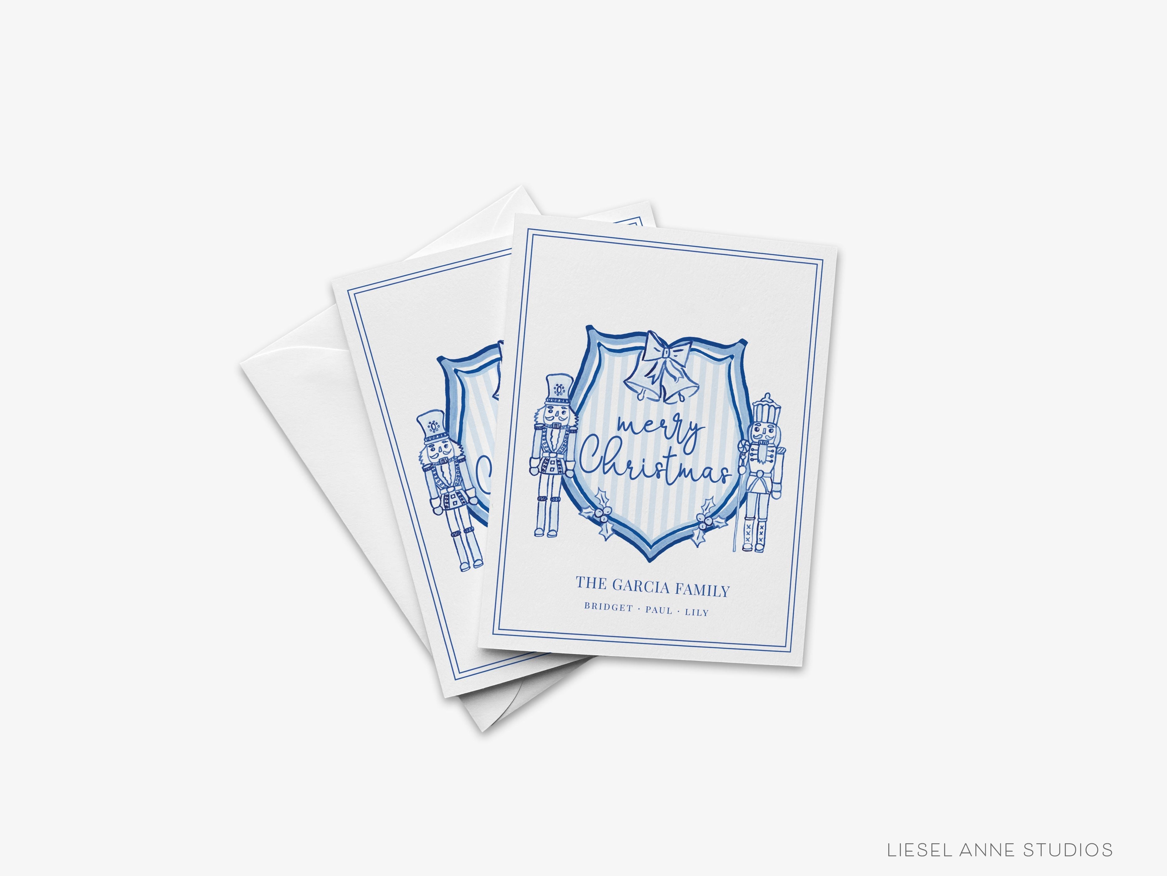 Personalized Christmas Crest Blue and White Cards-These folded greeting cards are 4.25x5.5 and feature our hand-painted Nutcracker Crest, printed in the USA on 100lb textured stock. They come with a White or Kraft envelope and make a great just because card for the Christmas lover in your life.-The Singing Little Bird