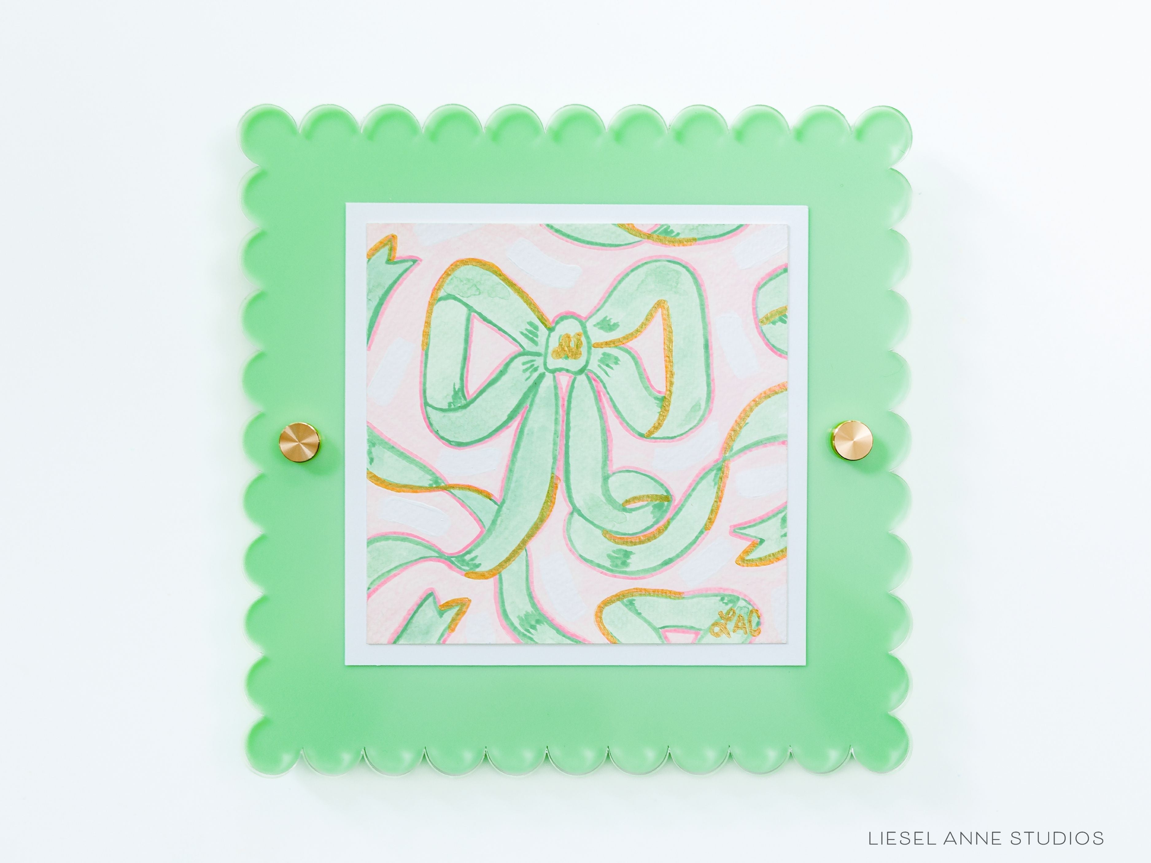 Pink & Green Golden Bows Art Print [5x5]-Art Print measures 5"x5" | Optional coordinating frame add on with hanging hardware and acrylic clear stand included | Features our signature Golden Bows design with a light pink base, light green bows and hand painted shimmery gold embellishments | Initialed in gold by Liesel Anne (the artist) on the front and signed and dated on the back-The Singing Little Bird