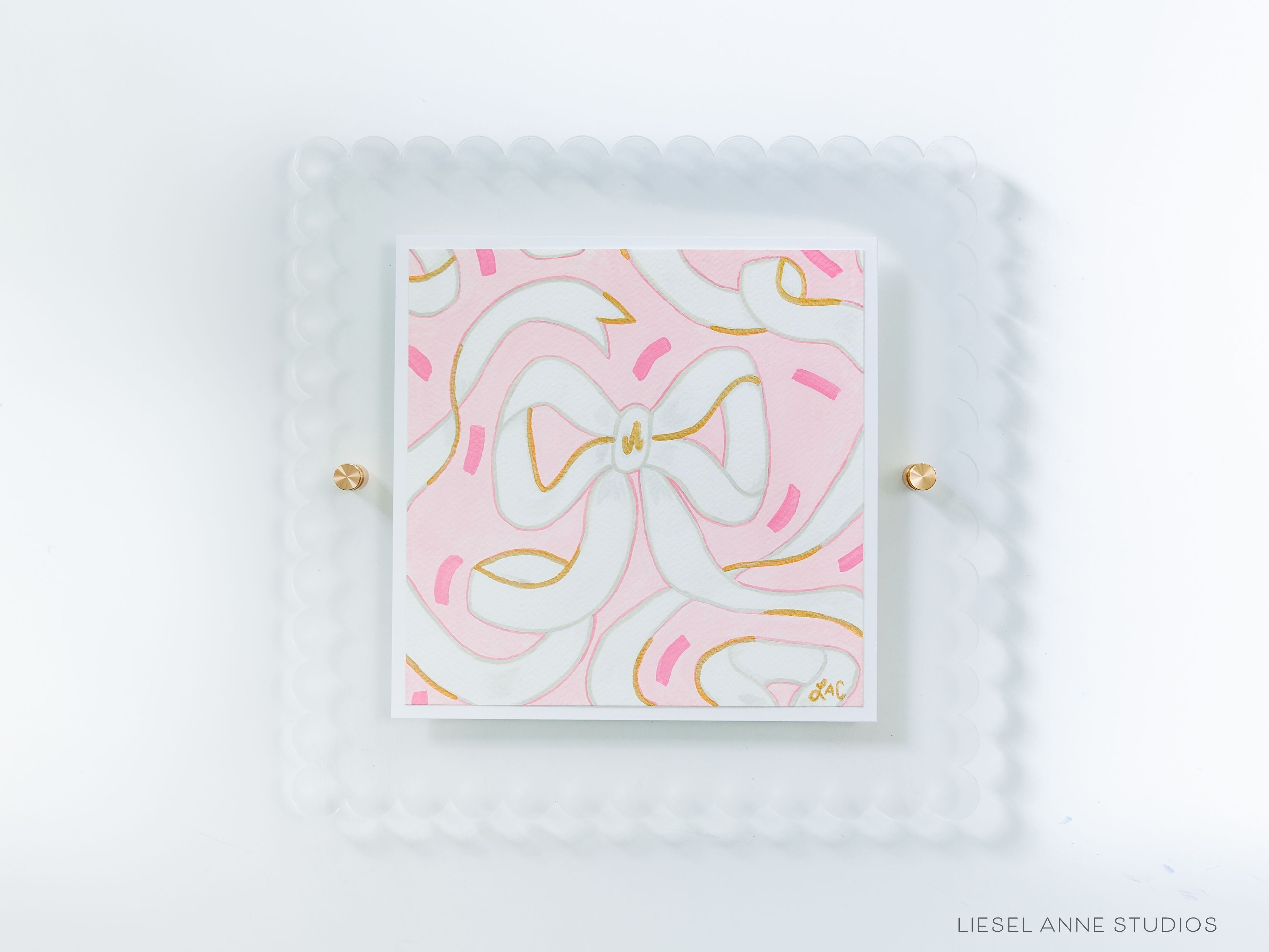 Pink & White Golden Bows Art Print [8x8]-Art Print measures 8"x8" | Optional coordinating frame add on with hanging hardware and acrylic clear stand included | Features our signature Golden Bows design with a light pink base, white bows and hand painted shimmery gold embellishments | Initialed in gold by Liesel Anne (the artist) on the front and signed and dated on the back-The Singing Little Bird