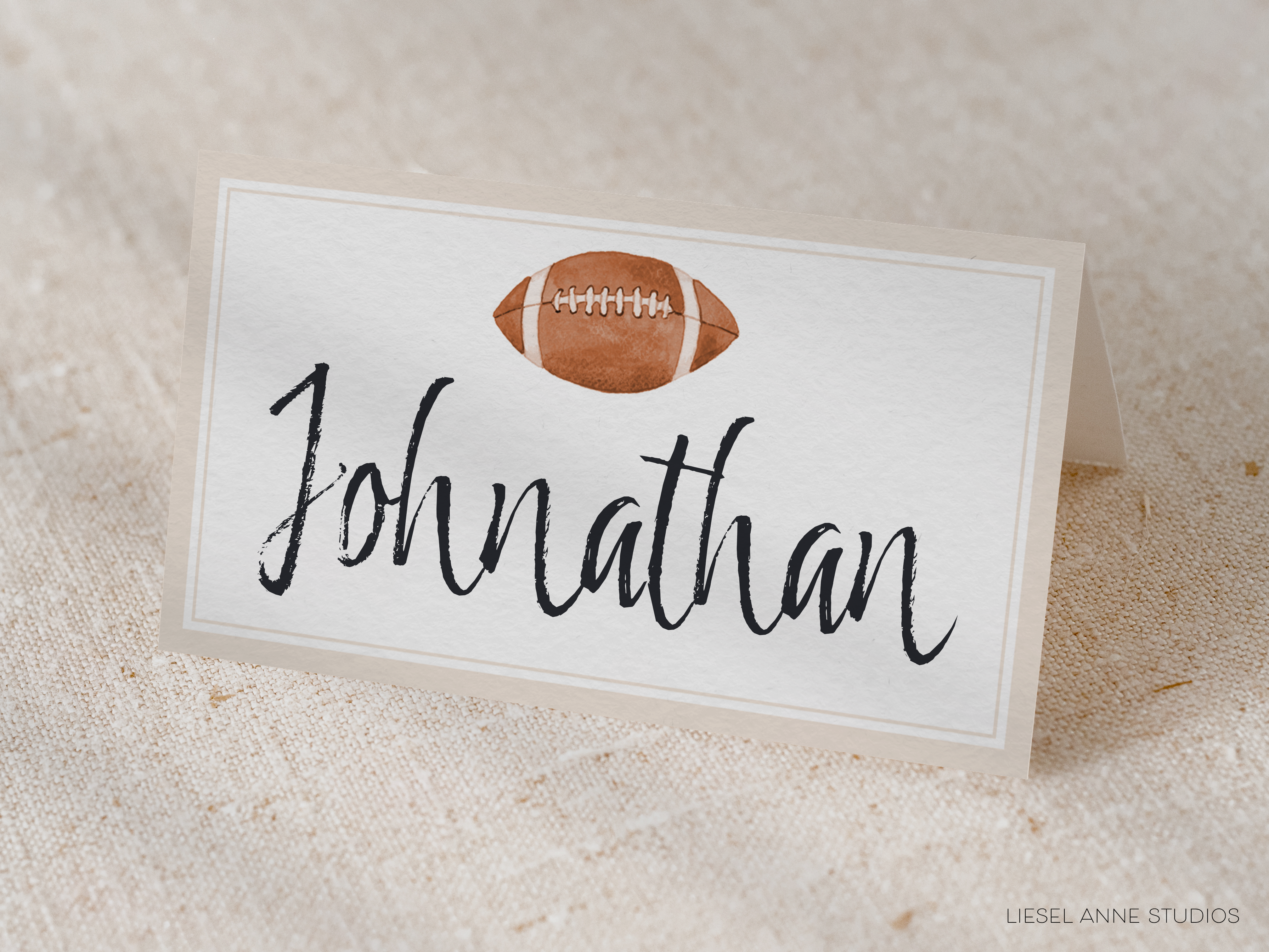 A white rectangular card with the name "Johnathan" written on it, along with an image of a football.