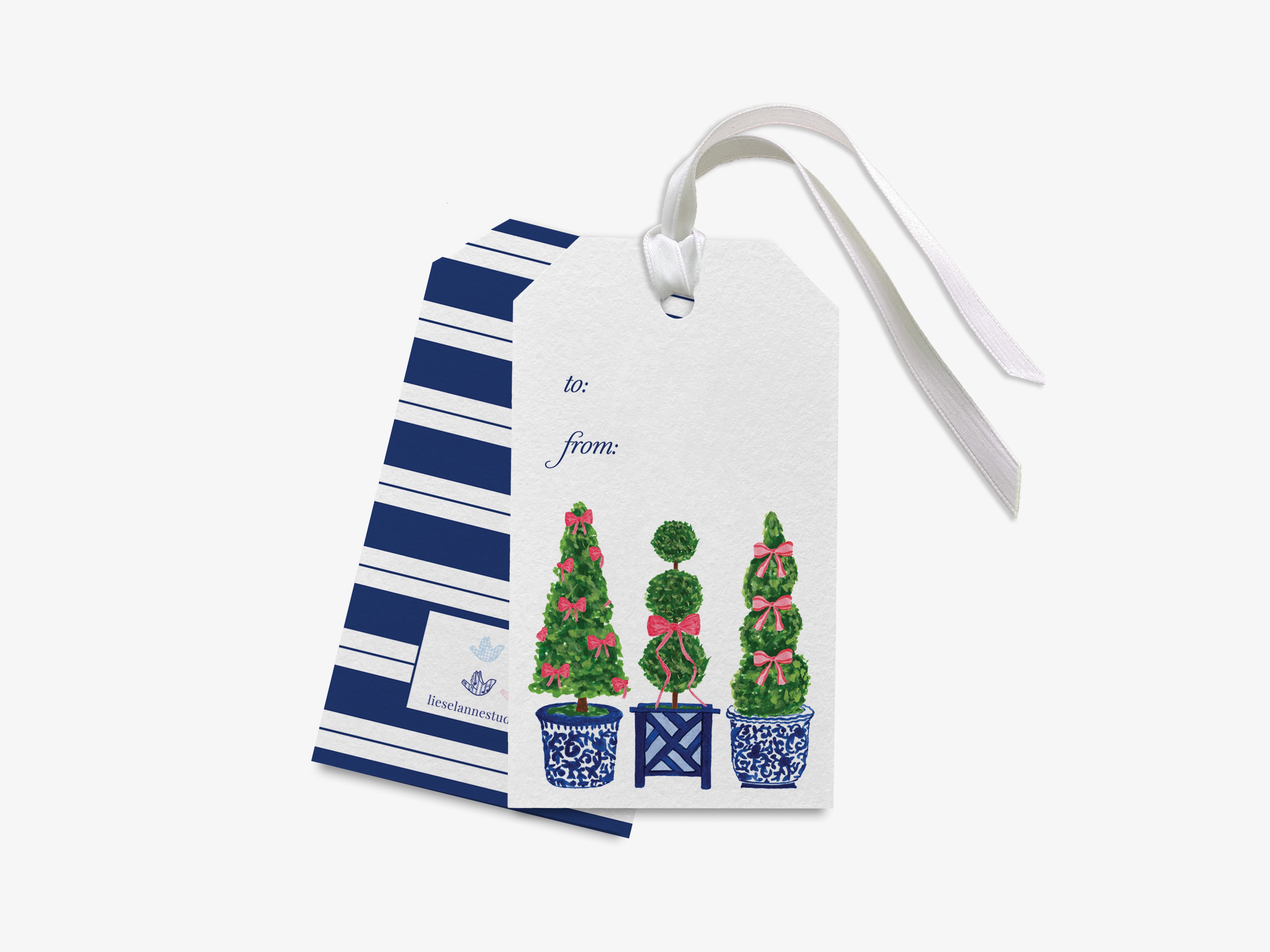 A white gift tag with a blue and white striped pattern, featuring illustrations of three topiary trees with bows on top.