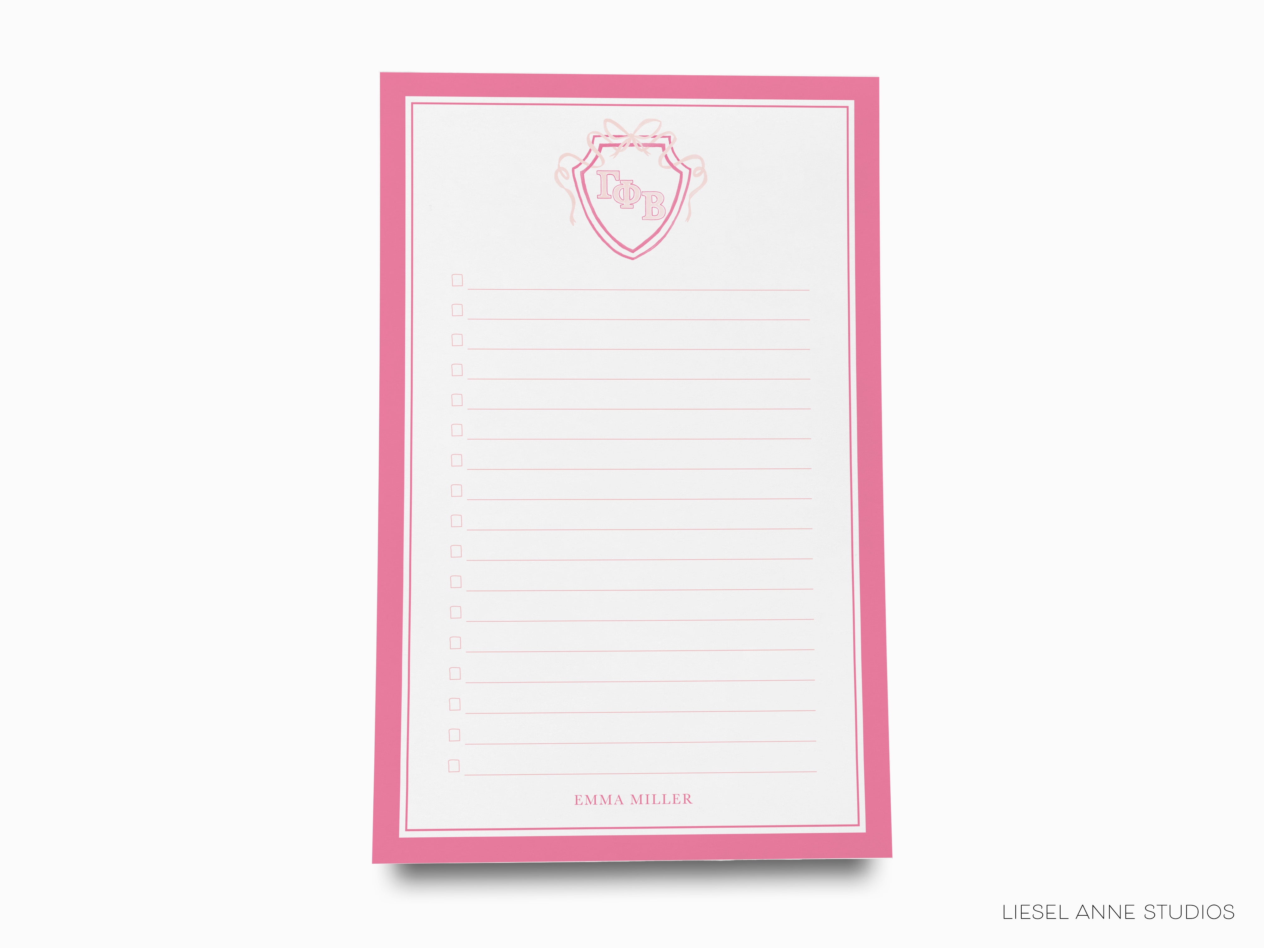 a pink notepad with a picture of a cup on it