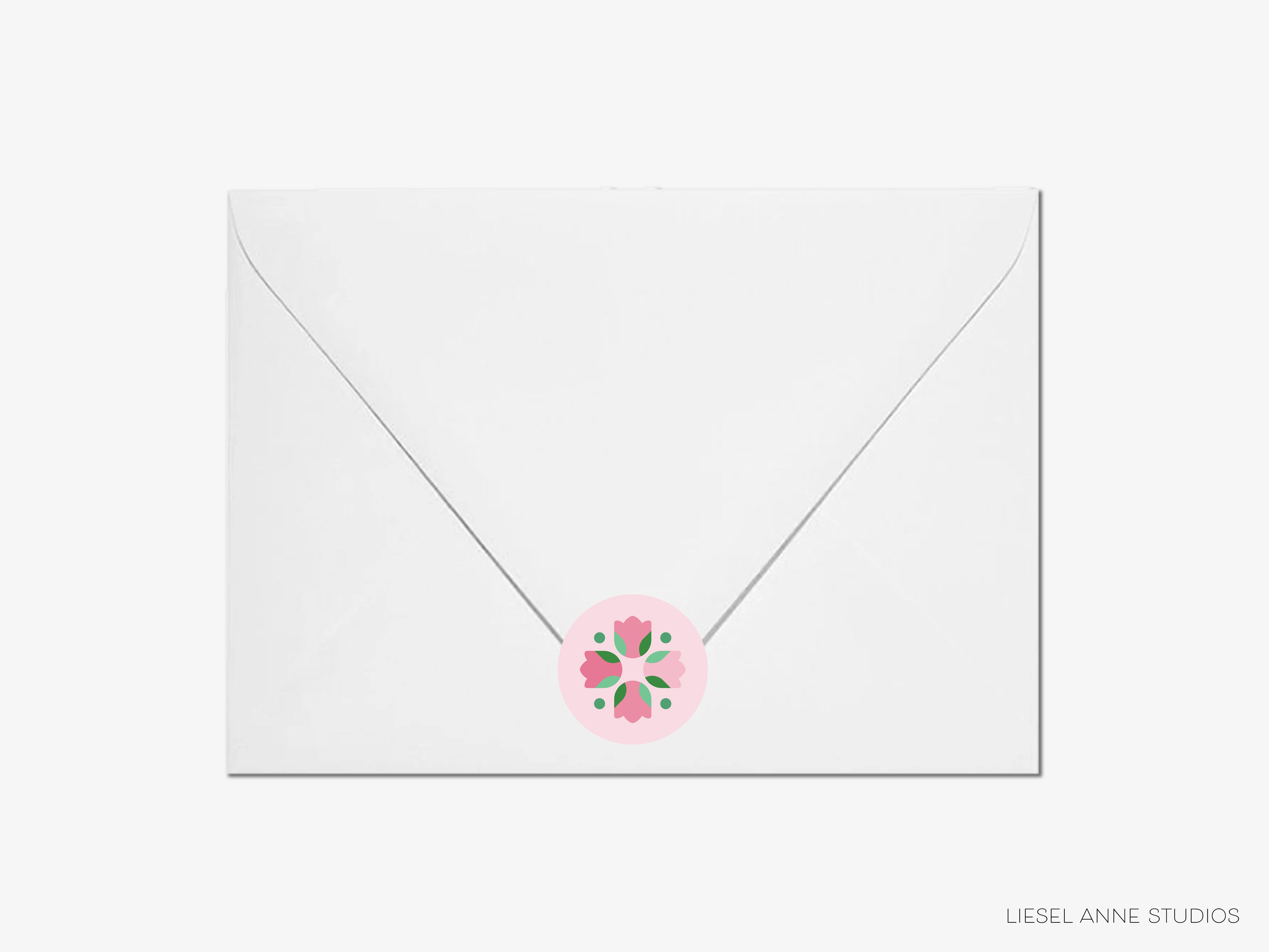 A white envelope with a pink floral design on the flap.