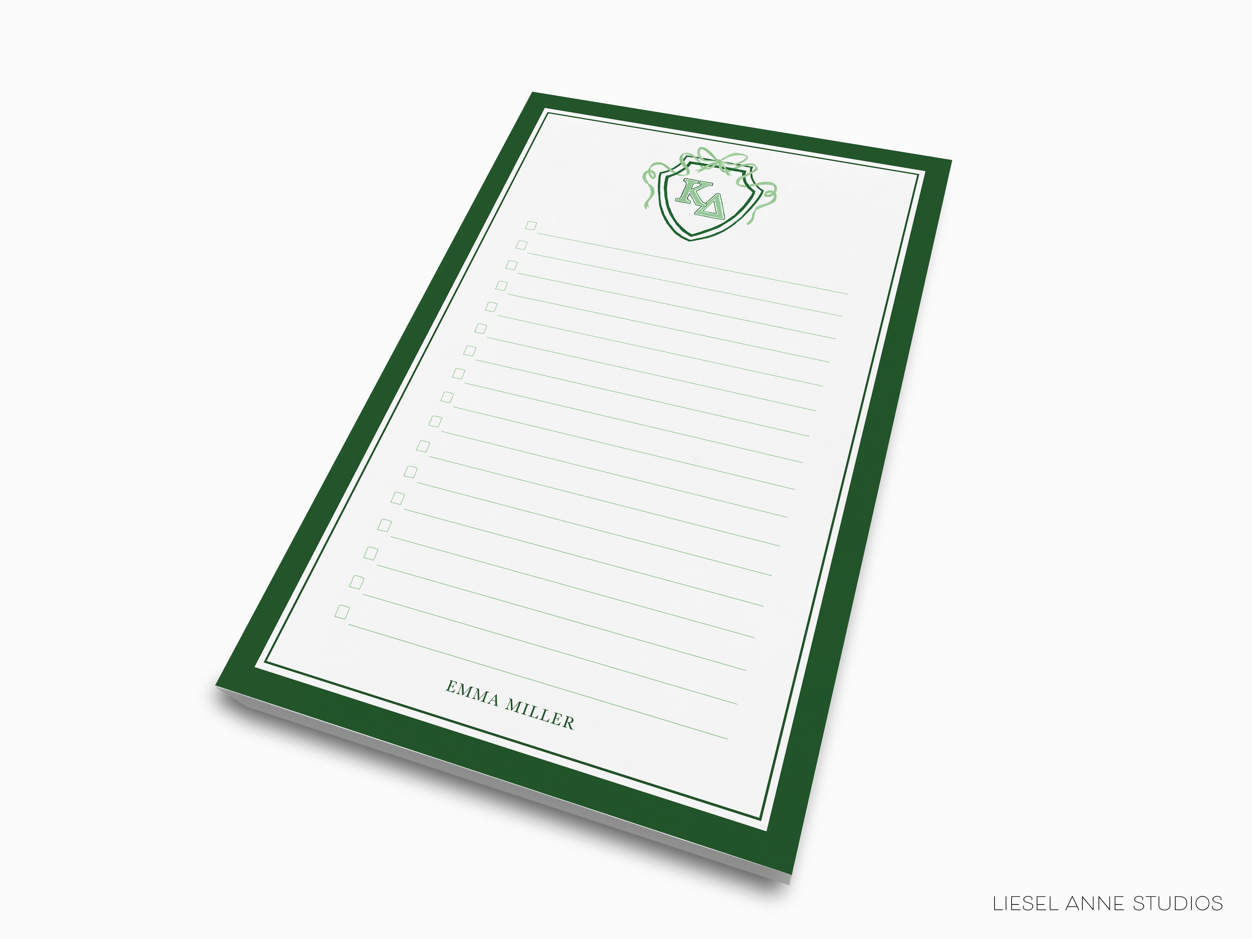 a green and white notepad with a crest on it