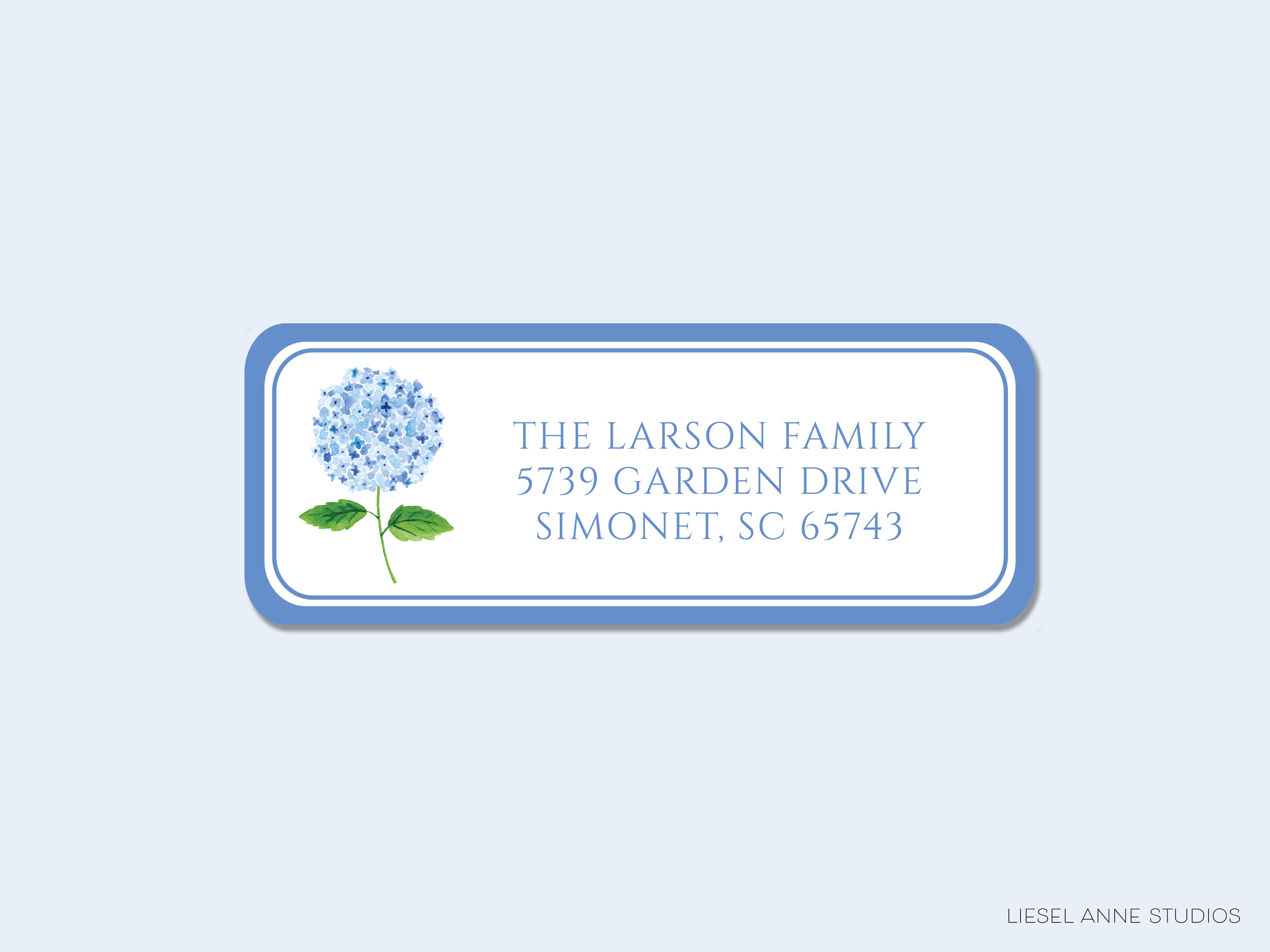 The image is a rectangular address label with a blue border and white background. It displays the address "The Larson Family 5379 Garden Drive Simonet, SC 65743" along with a watercolor illustration of a blue hydrangea flower.