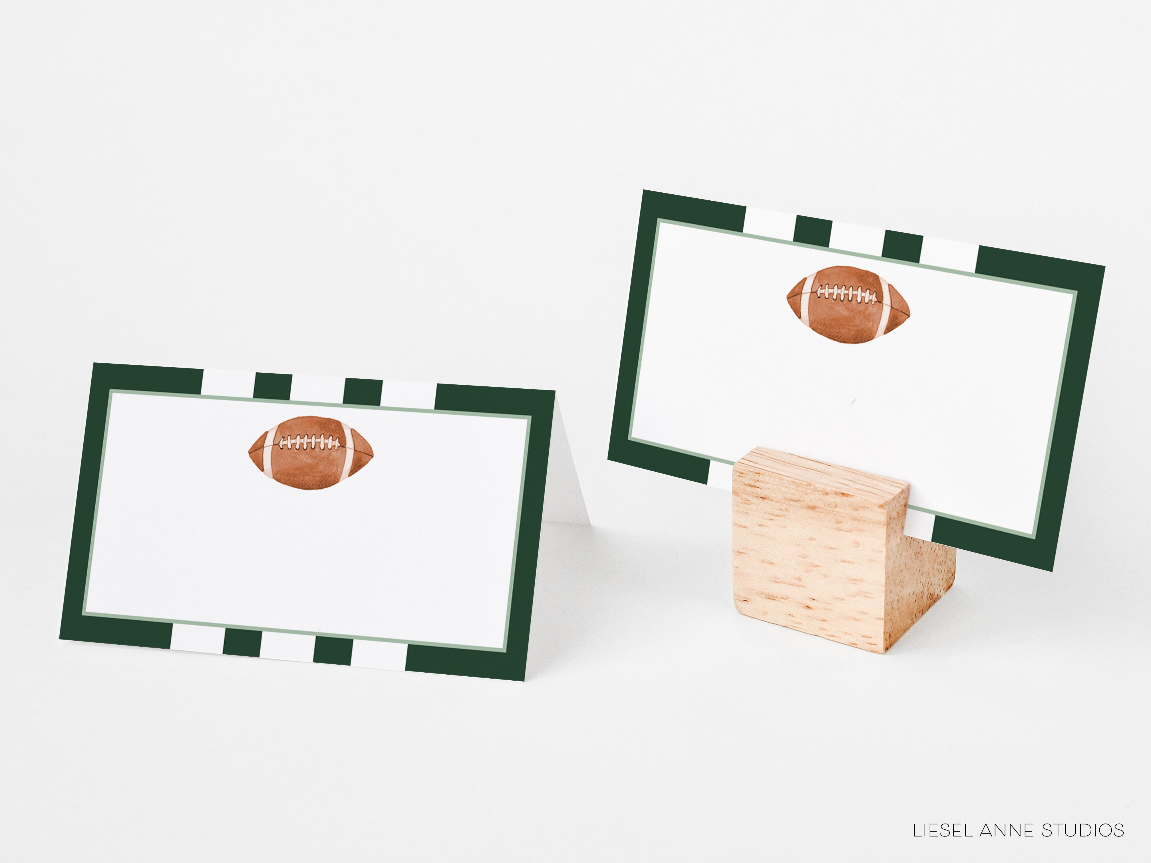 two place cards with a football design, placed on a wooden stand.