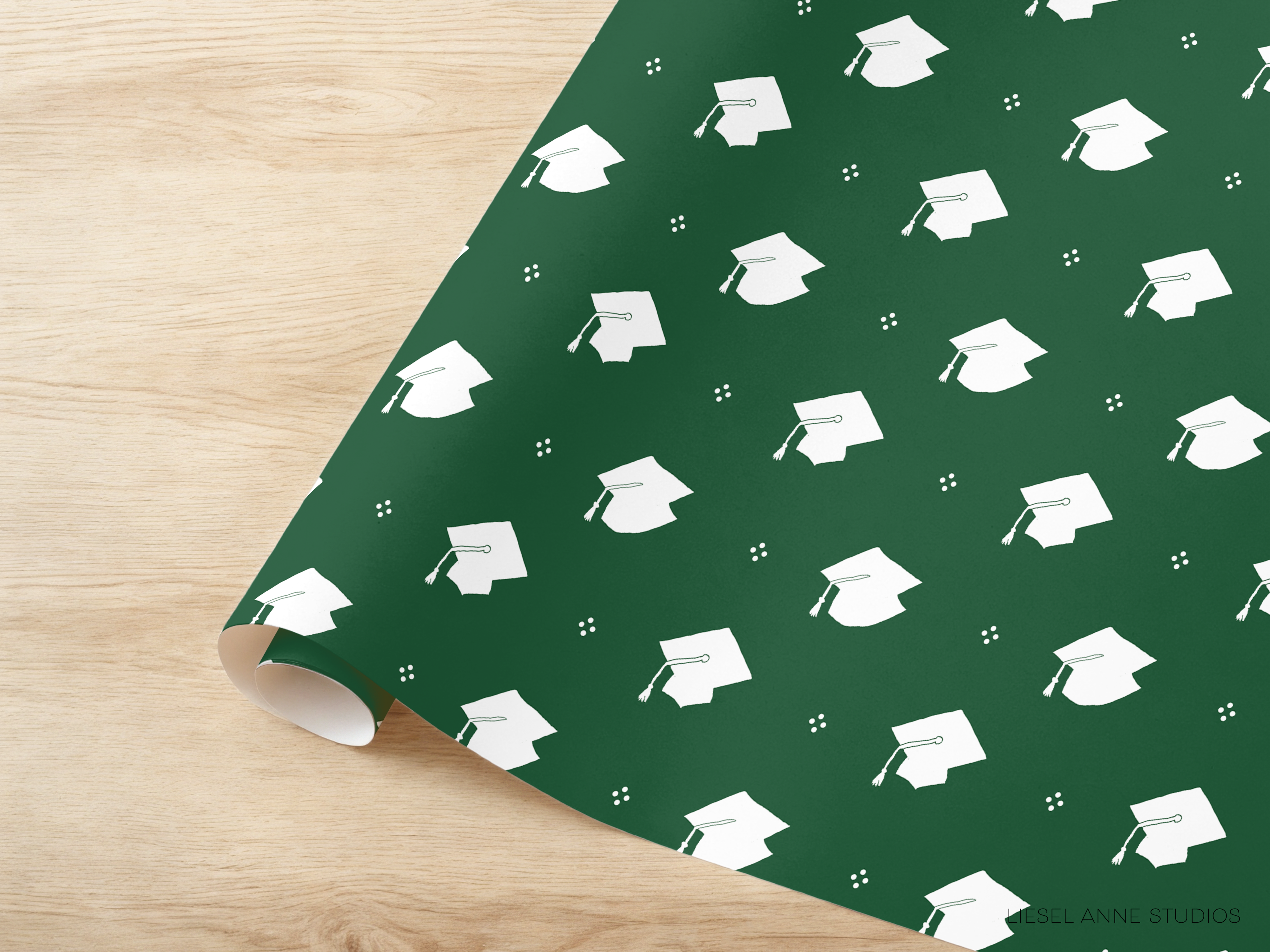 a pattern of white graduation caps on a green background.