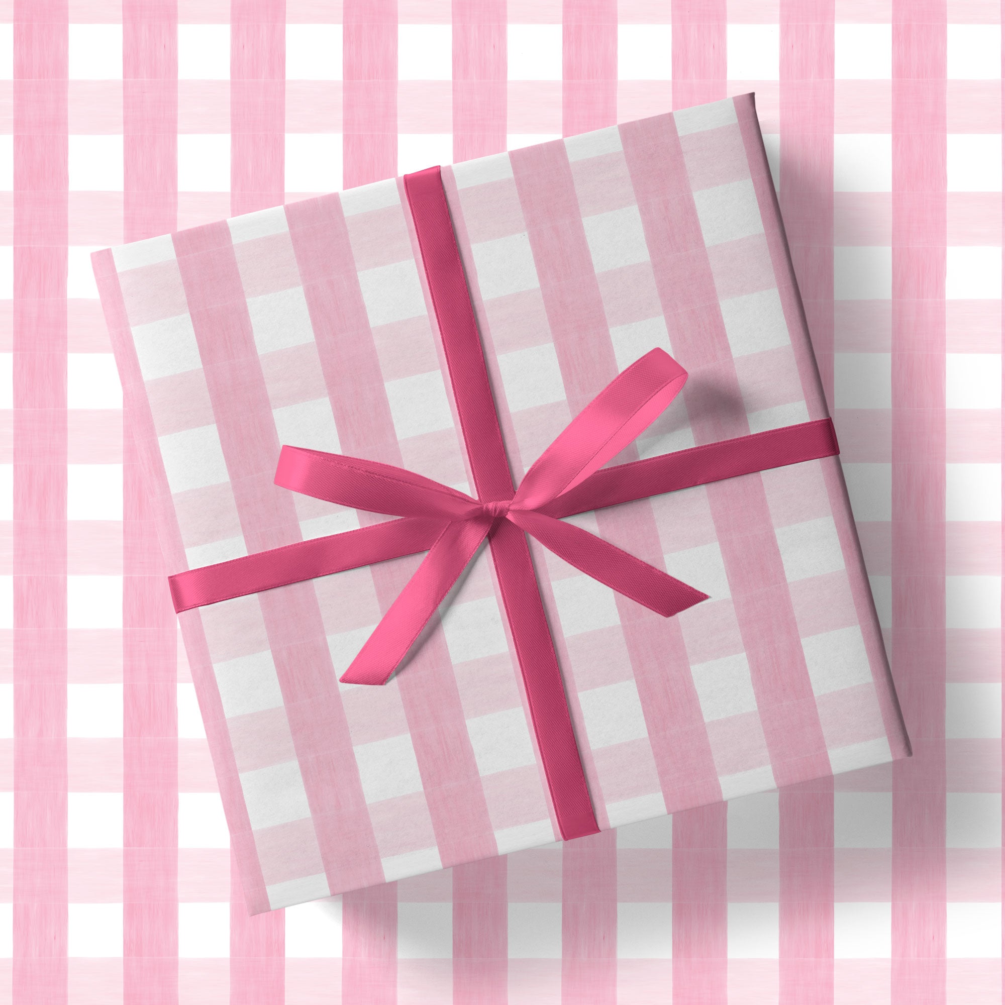A pink and white checkered gift box with a pink ribbon tied around it, placed on a pink and white checkered background.