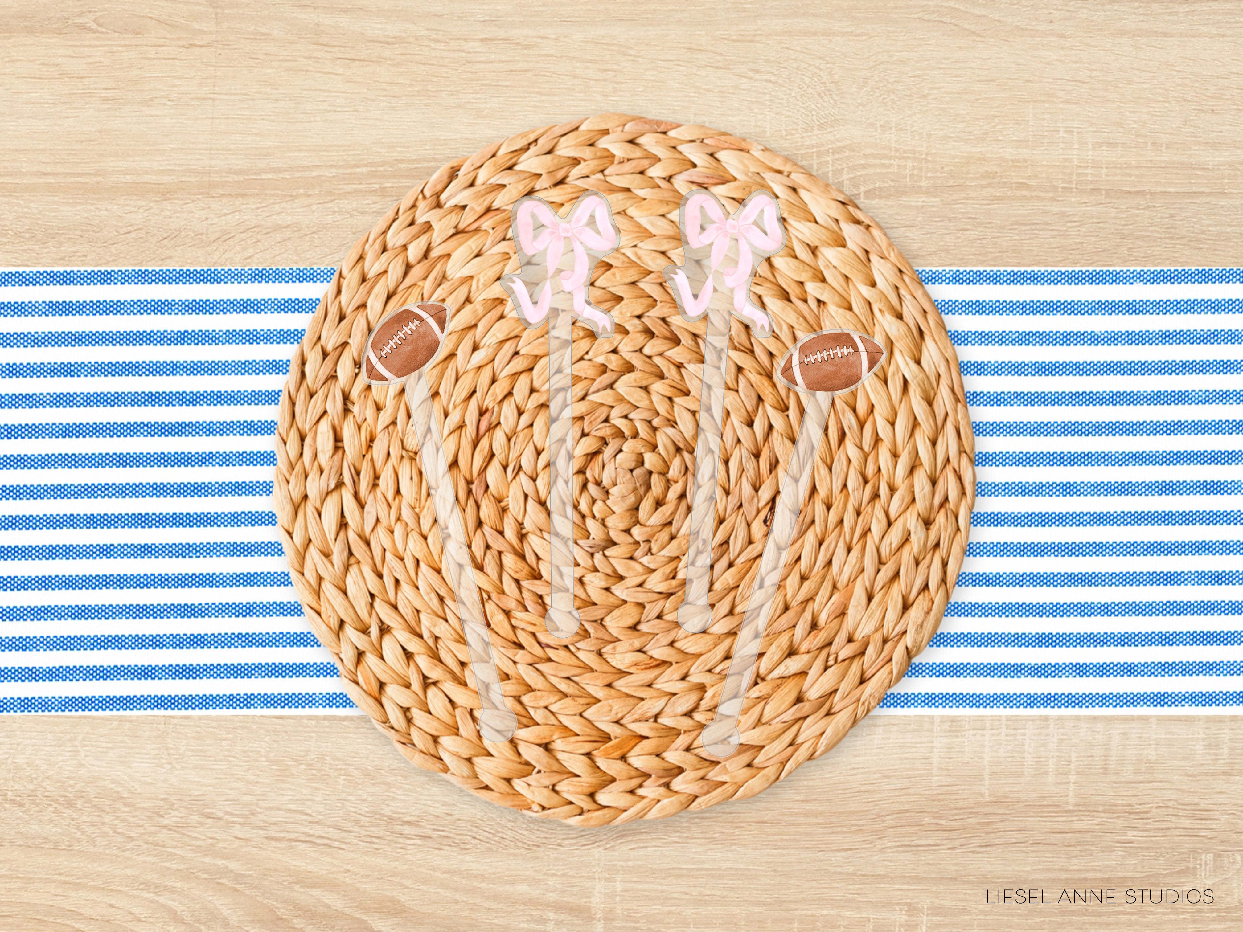 A woven placemat with a football and two pink bows on it, placed on a blue and white striped tablecloth.
