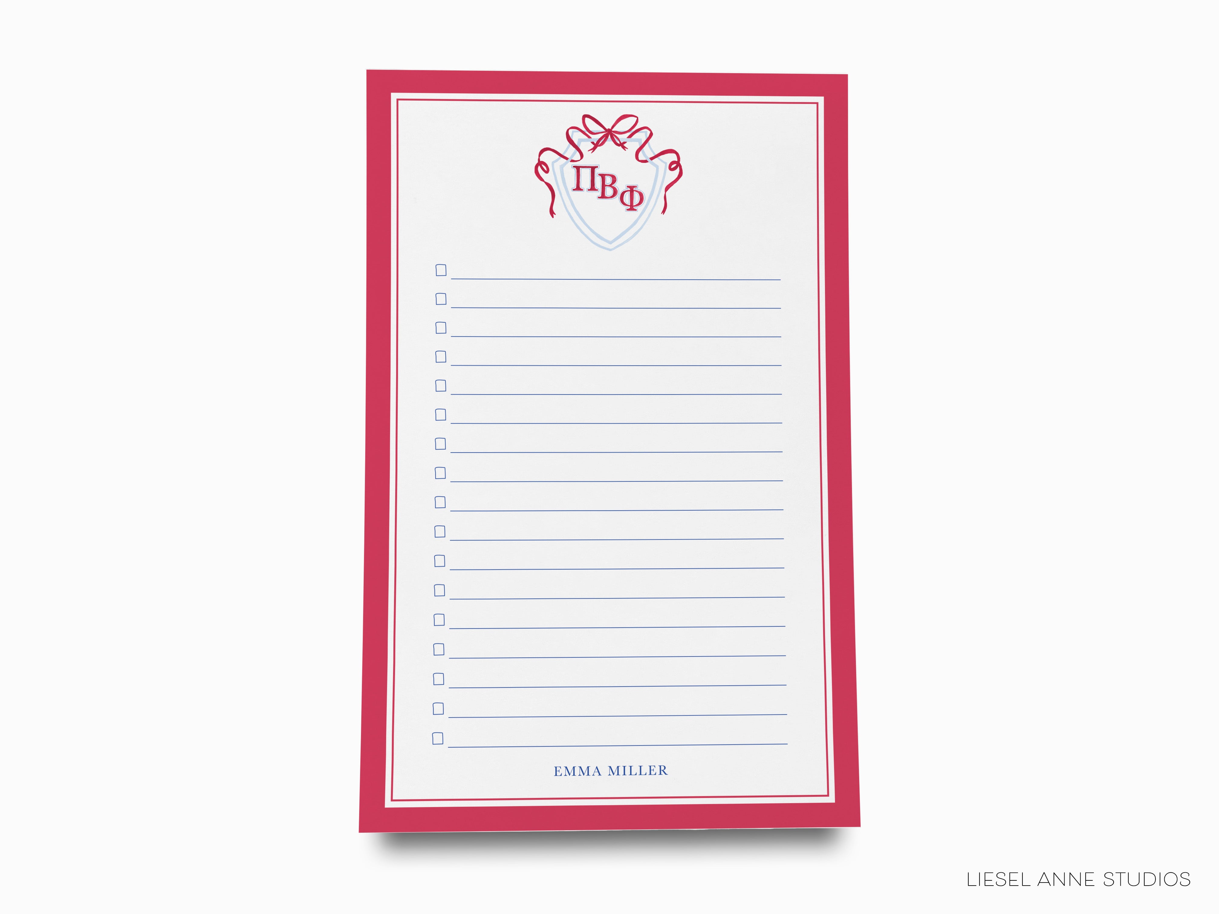 a red and white notepad with writing on it